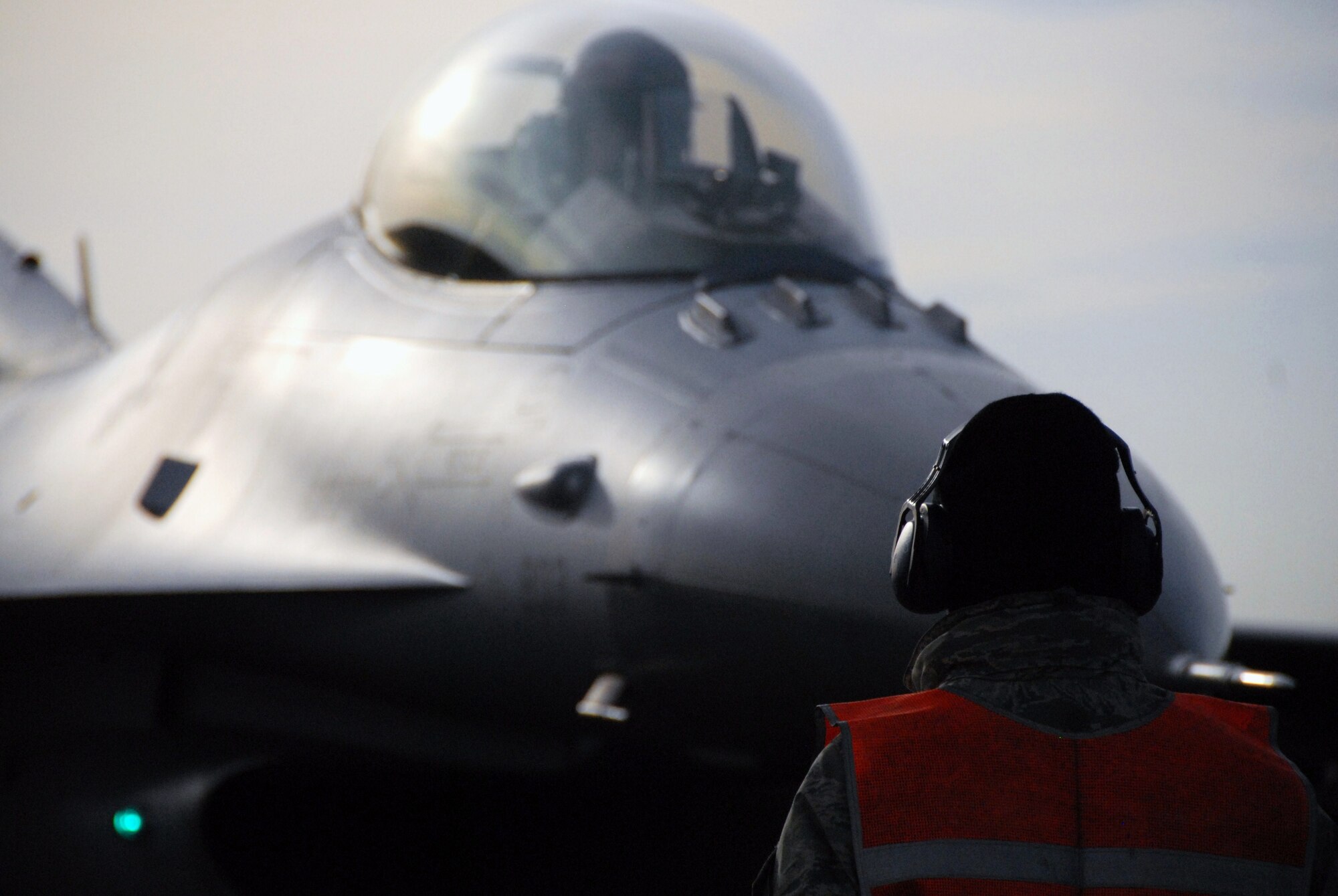 U.S. Air Force Staff Sgt. Yeakel Nikolai, 35th Aircraft Maintenance Squadron weapons load crew chief, marshals an F-16 Fighting Falcon pilot following a weapons de-arming inspection on the Komatsu Japan Air Self-Defense Force base runway. The pilots returned from a flying exercise in support of Keen Sword 2011. During Keen Sword 2011, units from the United States Army, Navy, Air Force and Marine Corps, conduct training with their Japan Self-Defense Force counterparts at military installations throughout mainland Japan, Okinawa and in the waters surrounding Japan. (U.S. Air Force photo by 1st Lt. Cammie Quinn)