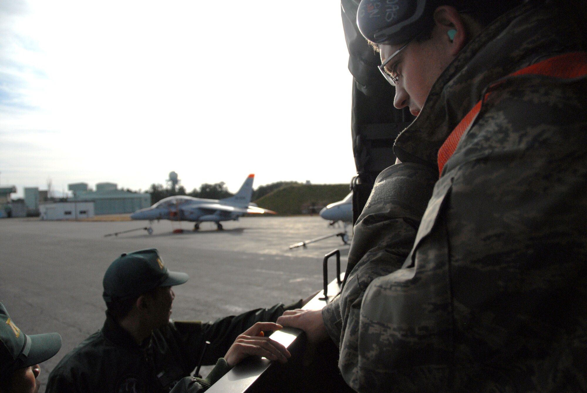U.S. Air Force Staff Sgt. Yeakel Nikolai, 35th Aircraft Maintenance Squadron weapons load crew chief, discusses the rules of engagement for de-arming F-16 Fighting Falcons with weapons load crew members from Komatsu Japan Air Self-Defense Force Base, during Keen Sword 2011, Dec. 6, 2010. Keen Sword is designed to allow the United States and Japan to practice and evaluate the coordination procedures and interoperability elements required to effectively and mutually respond to the defense of Japan, or to a regional crisis or contingency situation in the Asia-Pacific region, while building bilateral confidences and working relationships.  (U.S. Air Force photo by 1st Lt. Cammie Quinn)
