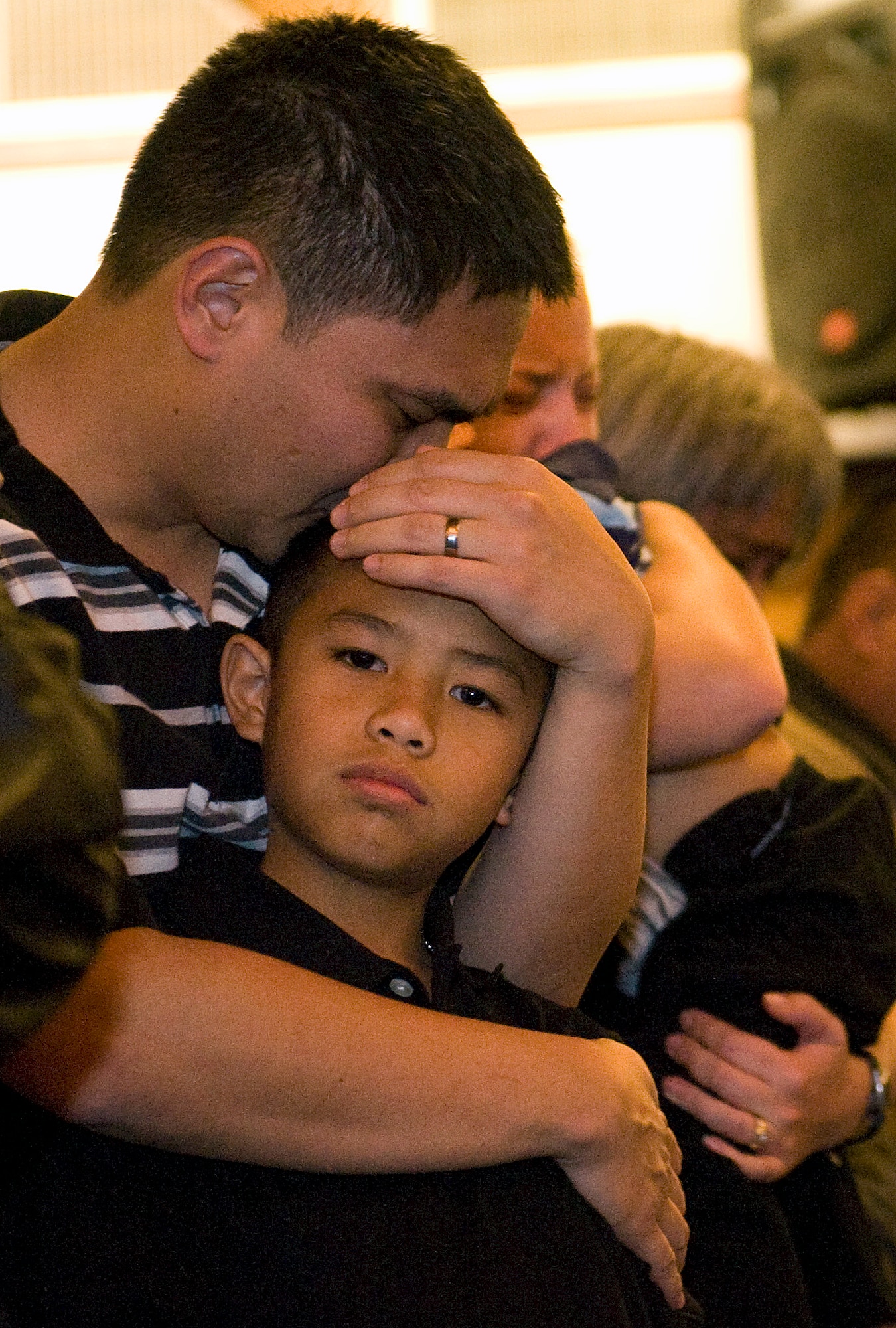 NELLIS AIR FORCE BASE, Nev.-- Eric Paet, brother of Staff Sgt. Nathan Paet, holds his nephew, Daynon, during Sergeant Paet's memorial service at the base Chapel Dec. 7. Sergeant Paet, 28, an F-15 supply section technician assigned to the 757th Aircraft Maintenance Squadron died from wounds suffered during a shooting at his off-base residence Dec. 1. (U.S. Air Force photo by Senior Airman Brett Clashman/Released)
