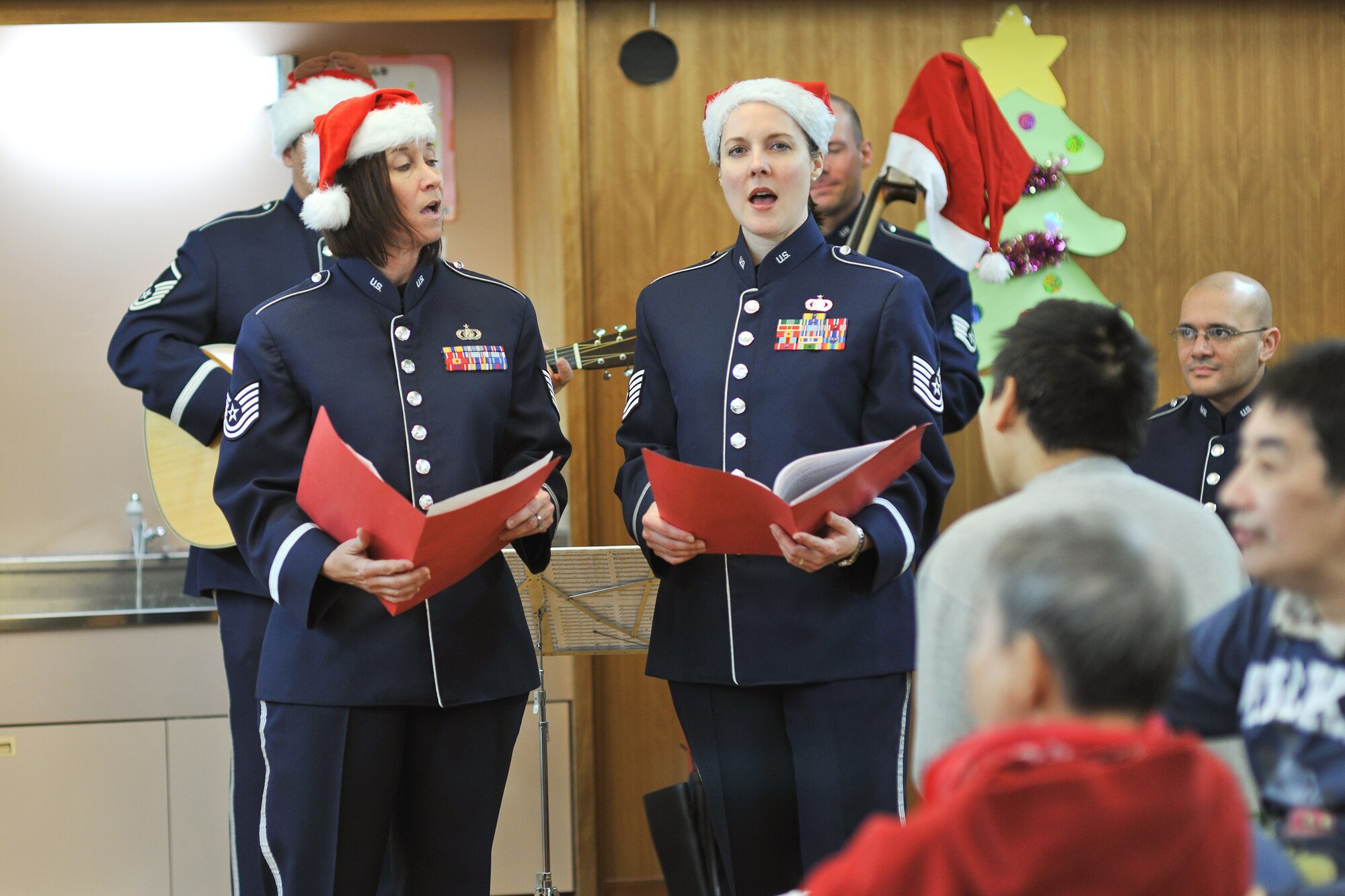 FUSSA, Japan -- Tech. Sgt. Rebecca Packard (left) and Tech. Sgt. Paula Goetz (right), both from the U.S. Air Force Band of the Pacific-Asia, perform carols at an off-base nursing home Dec. 7. (U.S. Air Force photo/Osakabe Yasuo)
