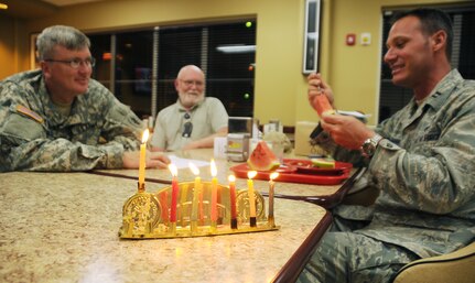 SOTO CANO AIR BASE, Honduras --  Chaplain (Capt.) Paul Cartmill, Mr. Bruce Drube and Chaplain (Capt.) Charles Seligman enjoy a meal together at the base dining facility after completing the ceremonial lighting of the Menorah during the Chanukah celebration Dec. 6. From the Hebrew word for "dedication" or "consecration," Hanukkah marks the rededication of the Temple in Jerusalem after its desecration by the forces of the King of Syria. (U.S. Air Force photo/Tech. Sgt. Benjamin Rojek)