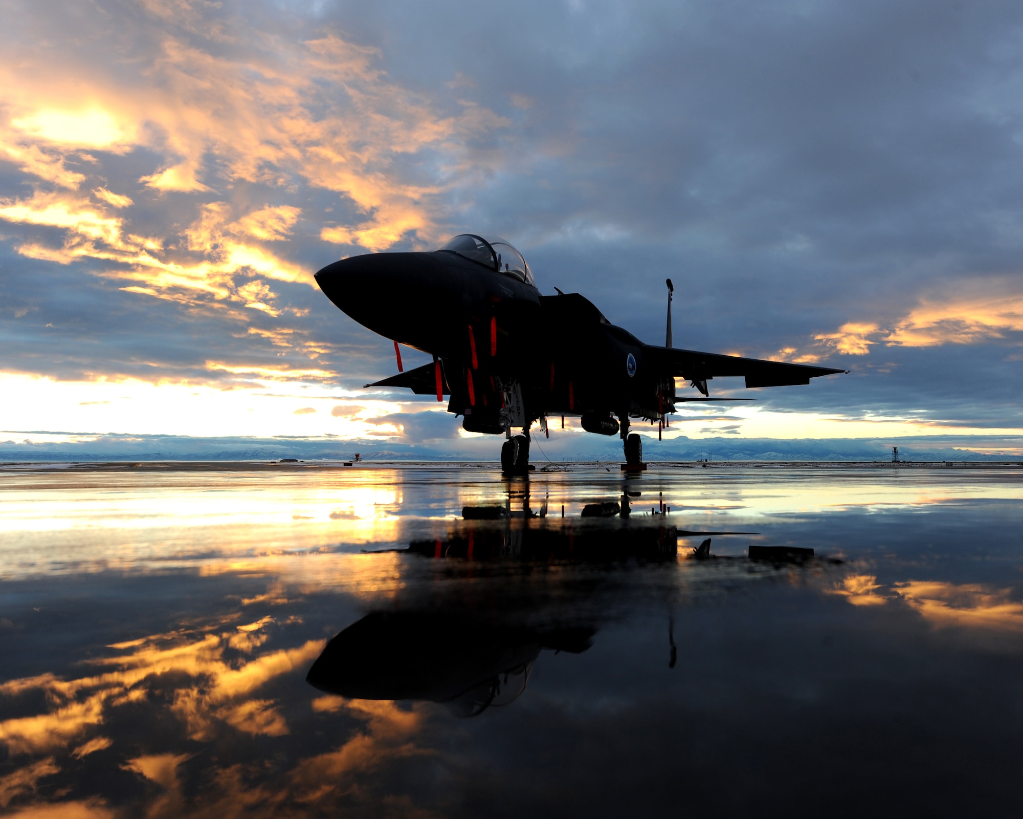 MOUNTAIN HOME AIR FORCE BASE, Idaho – The wing commander’s F-15E Strike Eagle assigned to the 389th Fighter Squadron sits on the flightline during sunset, Dec. 6. The low-altitude navigation and targeting infrared for night, or LANTIRN, system allows the F-15E Strike Eagle to fly at low altitudes, at night and in any weather conditions, to attack ground targets with a variety of precision-guided and unguided weapons. The LANTIRN system gives the aircraft unequaled accuracy in weapons delivery day or night and in poor weather, and consists of two pods attached to the exterior of the aircraft. (U.S. Air Force photo by Senior Airman Debbie Lockhart)