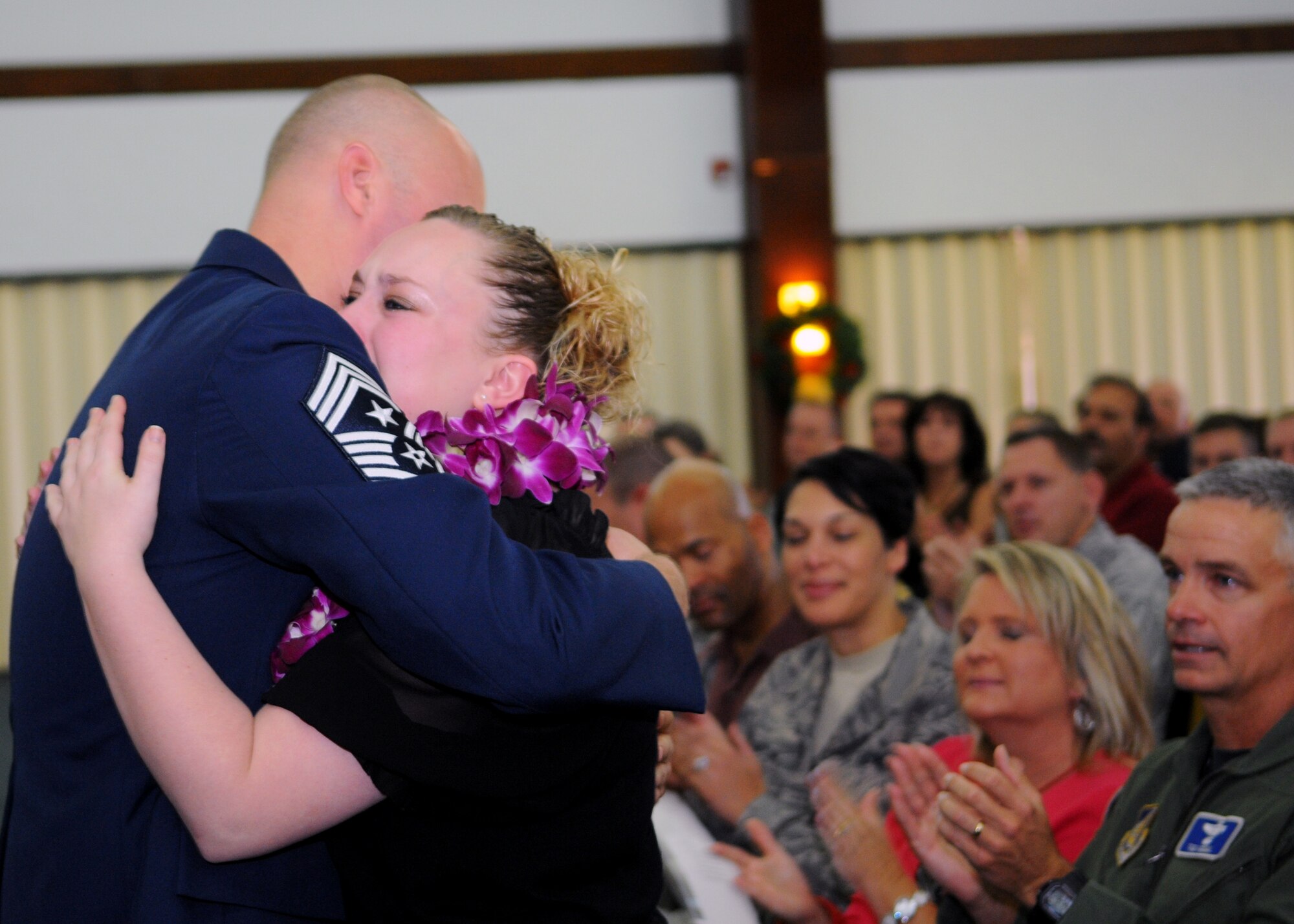 Alicia Mullinex embraces her father, former Command Chief Master Sgt. Allen Mullinex, during his retirement ceremony Dec. 3 at the Sunrise Conference Center. After an illustrious 25-year career, Chief Mullinex looks forward to completing his master's degree in business, snorkeling and learning how to dive. The outgoing command chief is being replaced by Chief Master Sgt. Margarita Overton, from the 78th Mission Support Group at Robins Air Force Base, Ga. (U.S. Air Force photo/ Senior Airman Nichelle Anderson)