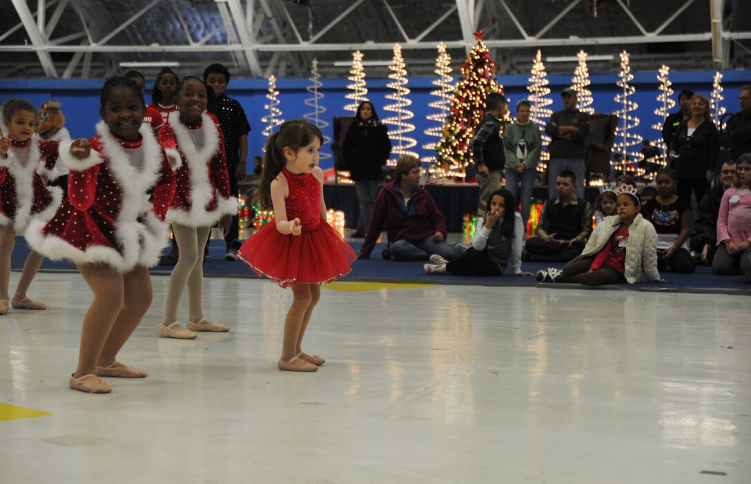 JOINT BASE ANDREWS, Md. -- Members of Agency 9 Performing Dance Company out of Clinton, Md., perform a dance number for attendees of the Parents and Children Fighting Cancer holiday party Dec. 4. Performing Dance Company is made up of children ages 5-16. They have performed at Howard University, national Christmas tree lighting ceremony, the Joint Base Andrews Air show and other Andrews events. (U.S. Air Force photo by Senior Airman Melissa V. Brownstein)