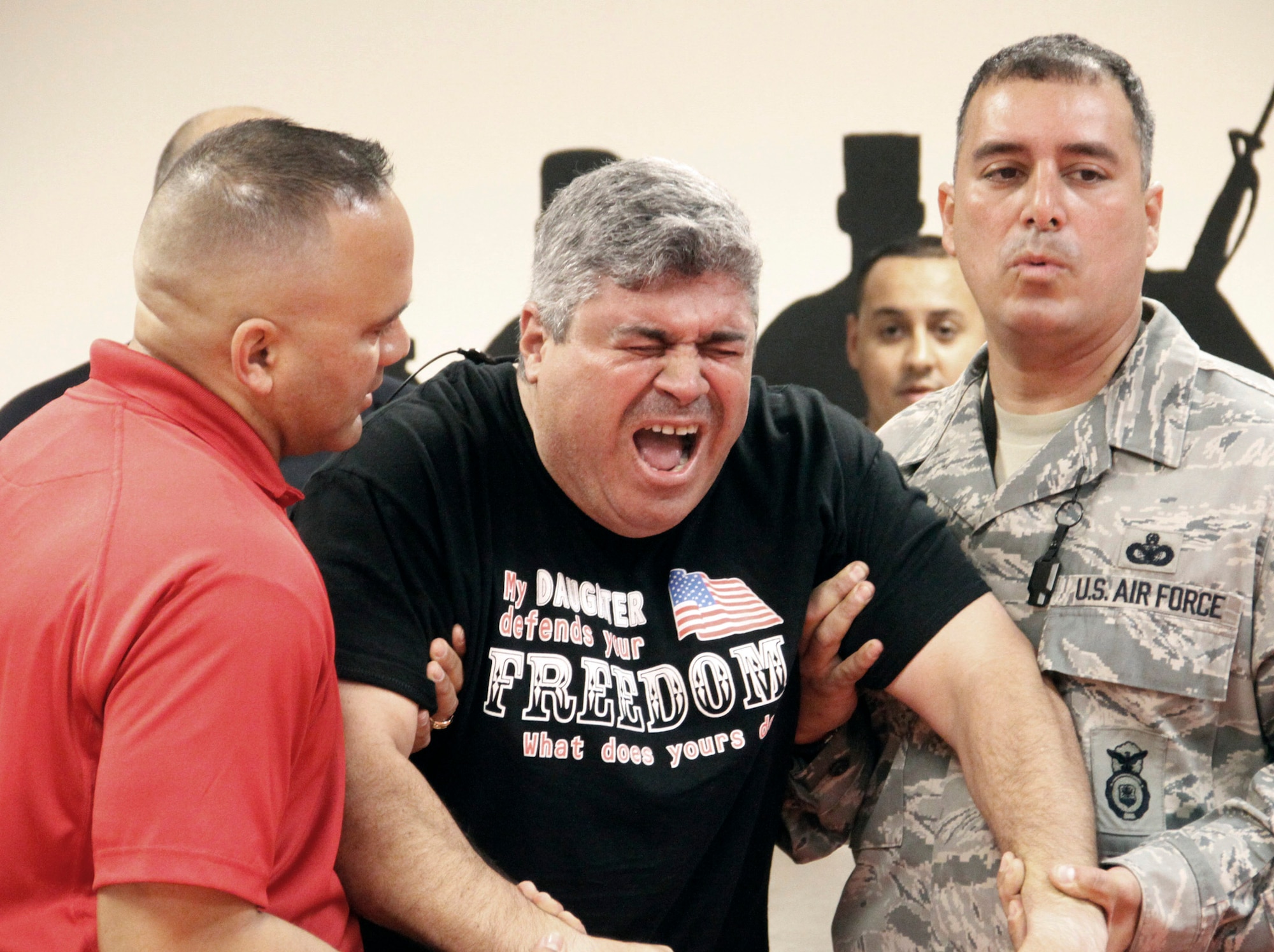 Lt. Juan Lemus, takes part in voluntary exposure training with a TASER gun, Dec. 1, 2010, at Homestead Air Reserve Base, Fla. Electrodes from a TASER were attached to the volunteers back, and for five seconds they felt what it was like to be on the receiving end. The 482nd Security Forces Squadron recently became the first unit in the Air Force Reserve Command to complete training with TASER guns, adding a new nonlethal option to their arsenal.  Lieutenant Lemus is the 482nd Security Forces Squadron Police Services chief. (U.S. Air Force photo/Ian Carrier)