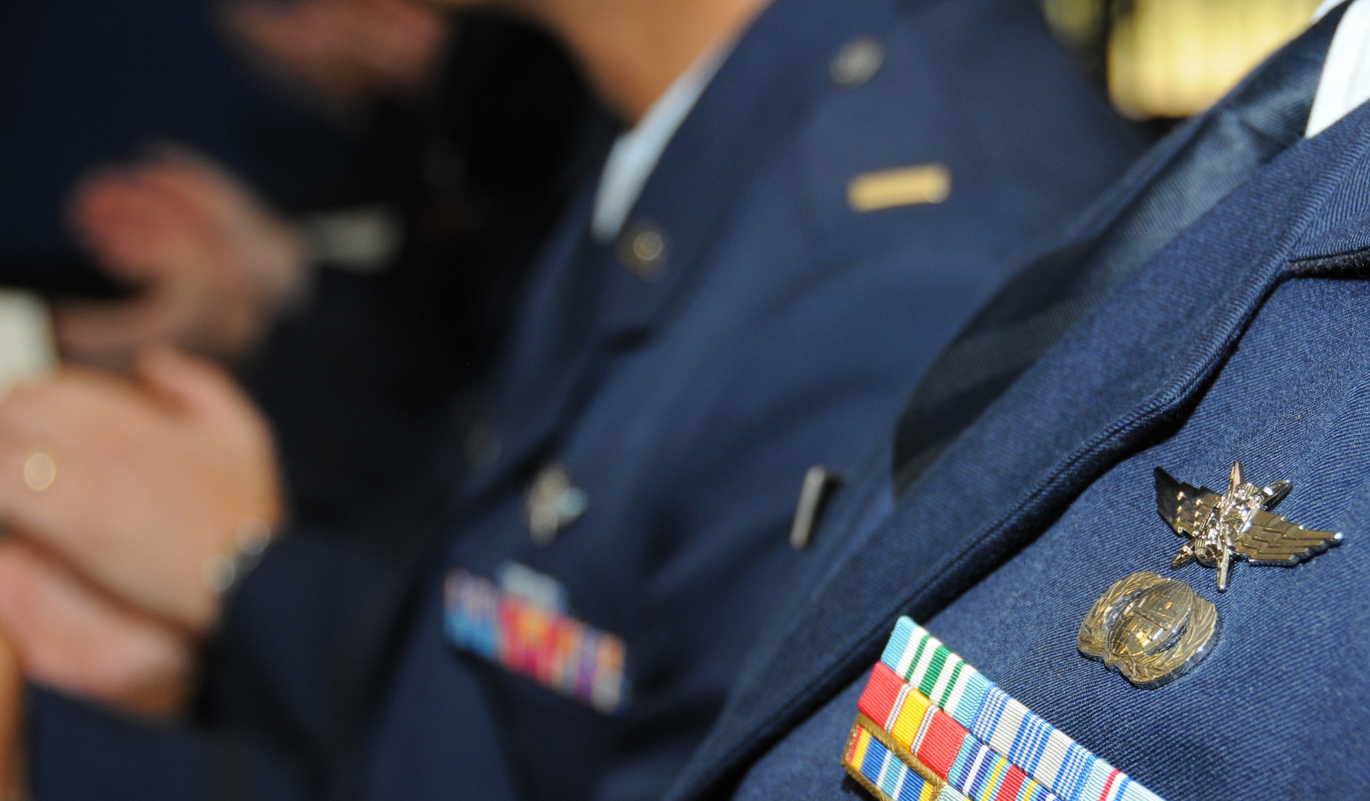 Graduates of the of the Air Force’s undergraduate cyberspace training course received the cyberspace officer badge. The lightning bolt wings signify the cyberspace domain and the globe represents the projection of cyber power.  The bolted wings centered on the globe are taken from the center of the Air Force seal and signify the striking power through air, space and cyberspace.  The orbits circling the globe signify the space-related elements of the cyberspace mission.  (U.S. Air Force photo by Kemberly Groue)

