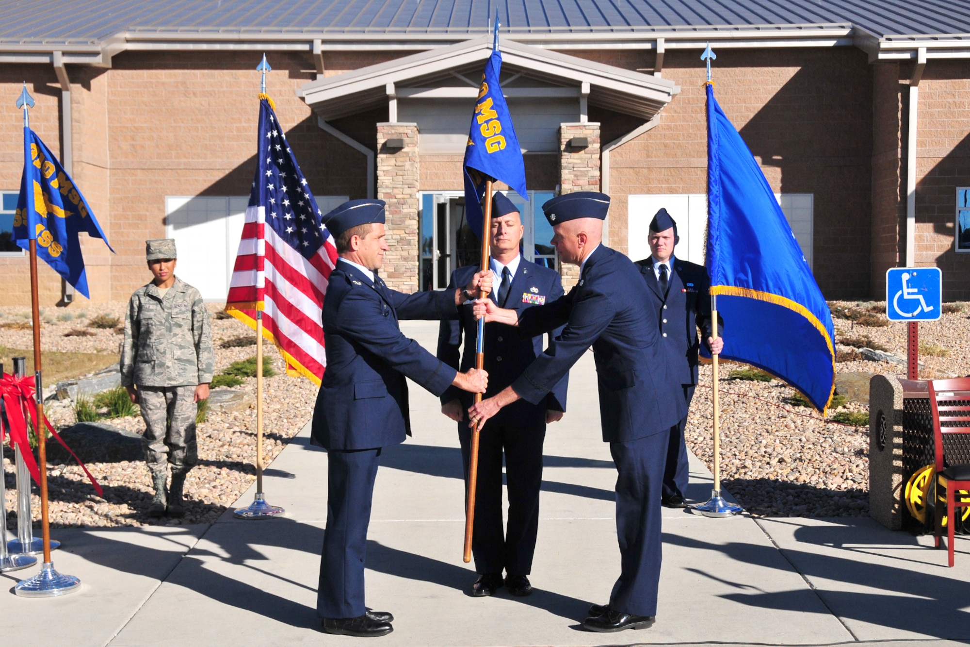 Col. Gene Odom, 310th Mission Support Group commander (left), presents the
310th Force Support Squadron guidon to Lt. Col. Kevin Graefe, 310 FSS
commander, after he assumed command of the unit at the 310 FSS Activation
ceremony on Nov. 7. During the ceremony, the 310 Mission Support Squadron was deactivated, followed by the activation of the 310 FSS. (U.S. Air Force photo by Tech. Sgt. Nick
Ontiveros)