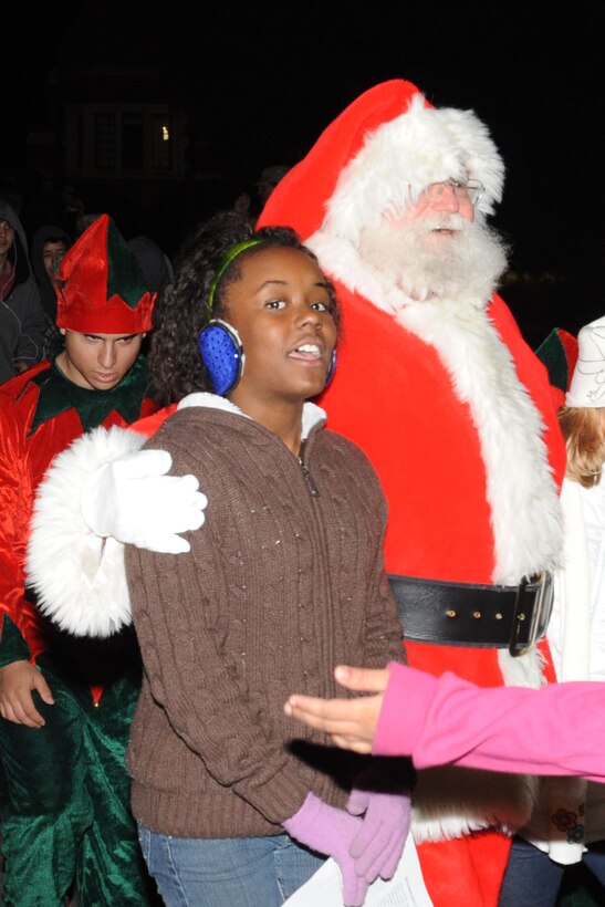 LANGLEY AIR FORCE BASE, Va -- Tamia Stamper, 10, daughter of Staff Sgt. Charles Stamper, 633d Air Base Wing chaplain assistant, walks with Santa while telling him what she wants for Christmas Dec. 1. Langley Air Force Base’s 43rd annual Christmas tree lighting ceremony kicked off the holiday season on the chapel lawn with seasonal music and a special visit from Santa Claus. (U.S. Air Force photo/Airman 1st Class Racheal Watson)(RELEASED)