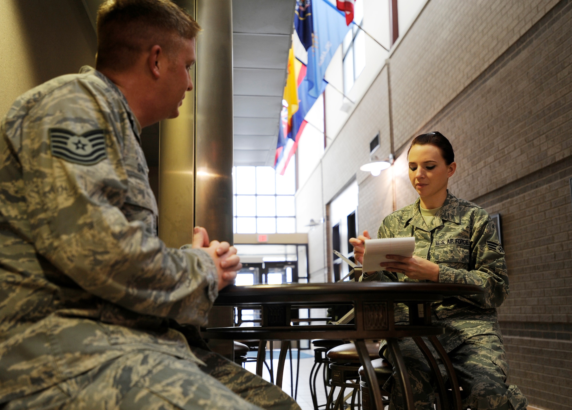 (Right) Senior Airman Abigail Klein, 22nd Air Refueling Wing Public Affairs journeyman, interviews Tech. Sgt. Brandon Swalla, 22nd Force Support Squadron First Term Airmen’s Center NCOIC Dec. 7, 2010, McConnell Air Force Base, Kan. Airman Klein is also the editor of the base paper “Tanker Times.” In addition to writing for the paper, the Wichita, Kan., native also ensures a positive image of McConnell is maintained throughout the community and local media outlets. (U.S. Air Force photo/Airman 1st Class Armando A. Schwier-Morales)    