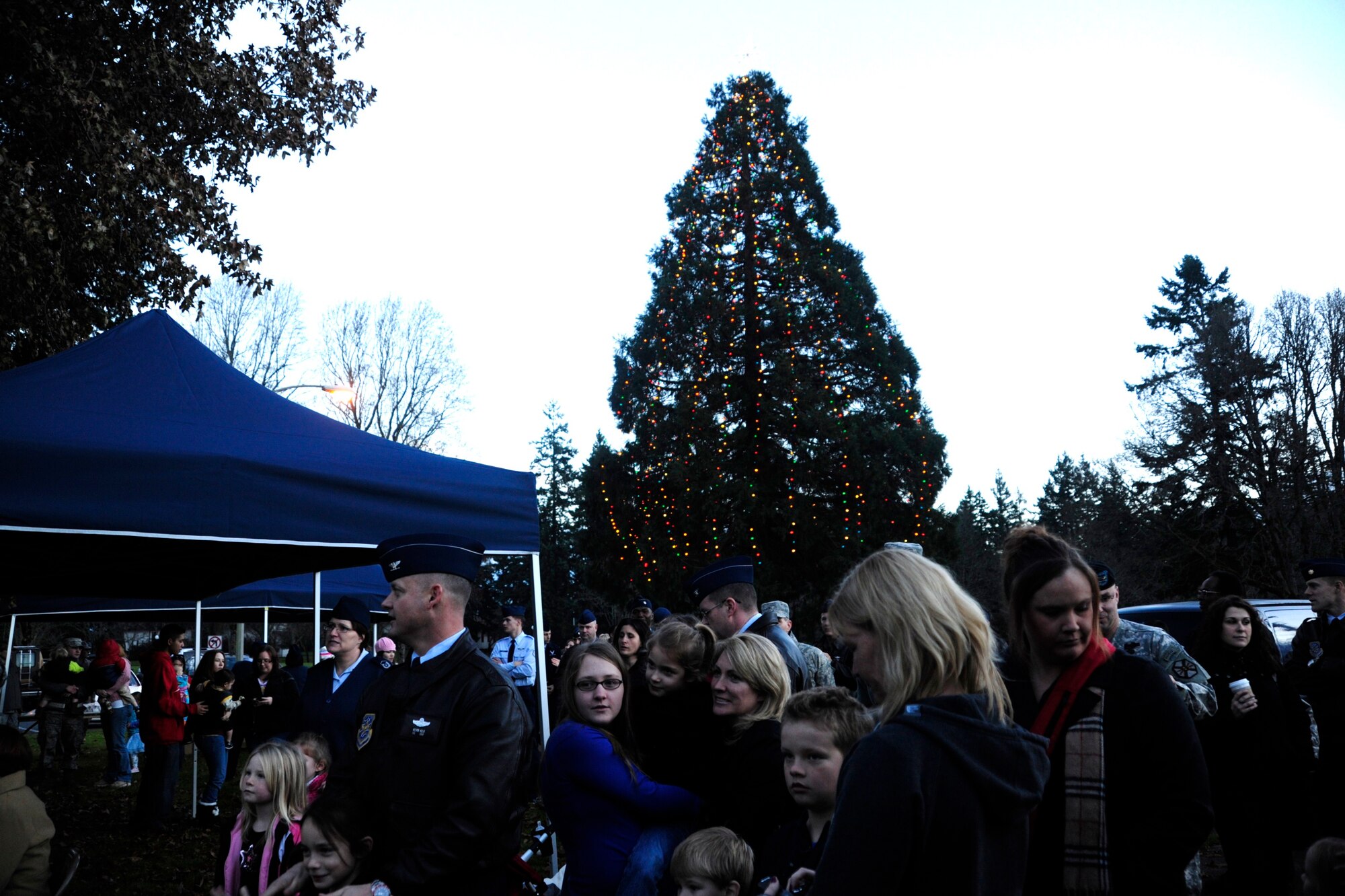 Friends and family sing holiday songs outside of the McChord Field Chapel Support Center Dec. 6 during the annual tree-lighting ceremony at McChord Field, Joint Base Lewis-McChord, Wash. (U.S. Air Force photo/Airman Leah Young)