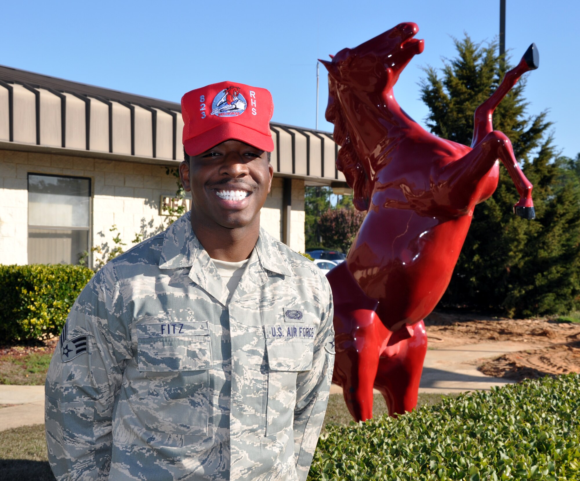 Senior Airman Datuan Fitz, 823rd Rapid Engineer Deployable Heavy Operational Repair Squadron Engineers Commander's Support Staff Personnel journeyman, poses next to a red horse statue outside his squadron's headquarters at Hurlburt Field, Fla., Dec. 7, 2010. Airman Fitz was selected for this week's Tip of the Spear spotlight. (DoD photo by U.S. Air Force Airman 1st Class Joe McFadden / RELEASED)