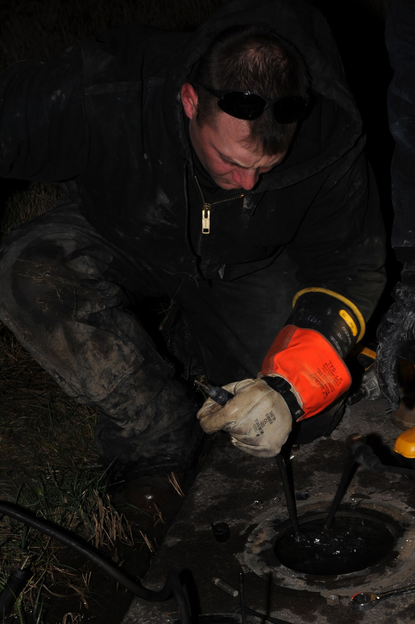 WHITEMAN AIR FORCE BASE, Mo. -- Staff Sgt. James Thompson, 509th Civil Engineer Squadron electrician, connects new transformer to circuit for runway-distance-remaining marker on 30 Nov. (U.S. Air Force photo/Staff Sgt. Jason Huddleston) (Released)
