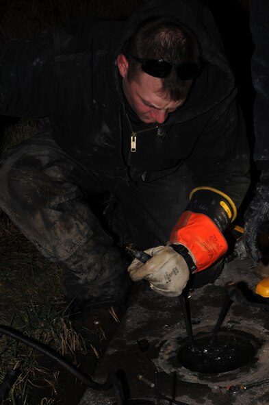 WHITEMAN AIR FORCE BASE, Mo. -- Staff Sgt. James Thompson, 509th Civil Engineer Squadron electrician, connects new transformer to circuit for runway-distance-remaining marker on 30 Nov. (U.S. Air Force photo/Staff Sgt. Jason Huddleston) (Released)
