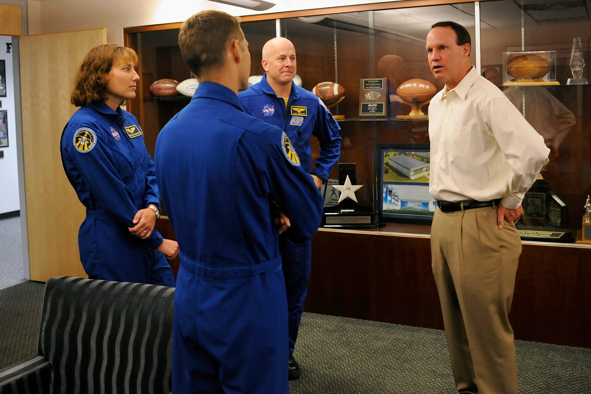 (From left) Dorothy Metcalf-Lindenberger, Col. Jim Dutton and Navy Capt. Alan Poindexter talk with Air Force football head coach Troy Calhoun during a "NASA victory tour" visit, May 18, 2010, to the U.S. Air Force Academy, Colorado Springs, Colo. The three astronauts were part of the crew for the Space Shuttle Atlantis' STS-131 mission to the International Space Station in April. (U.S. Air Force photo/J. Rachel Spencer)