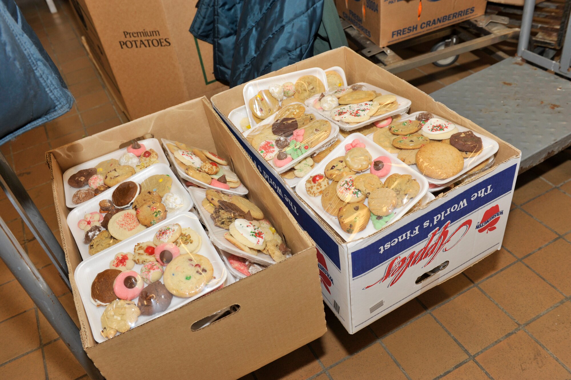 A box of cookies ready to be delivered to Airmen living in the dorms. Tyndall Officers Spouses Club and Tyndall Enlisted Spouses Club members sorted more than 414 holiday cookies onto plates they delivered to every Airman in a dorm room December 6. Cookie Caper is an annual program designed to make the holiday season a little brighter for the Airmen living in the dorms who may not have family close by. (U.S. Air Force photo Jonathan Gibson)