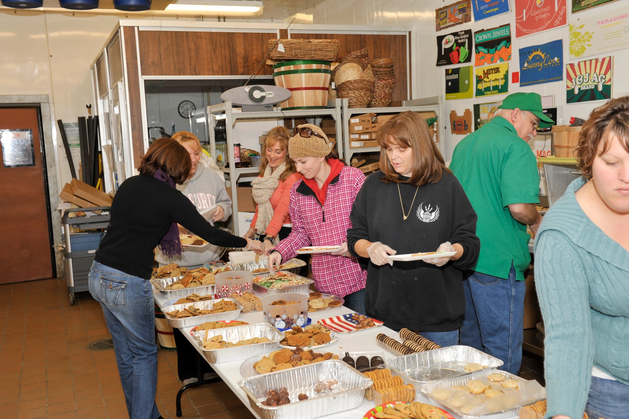 Tyndall Officers Spouses Club and Tyndall Enlisted Spouses Club members sort more than 414 holiday cookies onto plates they delivered to every Airman in a dorm room December 6. Cookie Caper is an annual program designed to make the holiday season a little brighter for the Airmen living in the dorms who may not have family close by. (U.S. Air Force photo Jonathan Gibson)