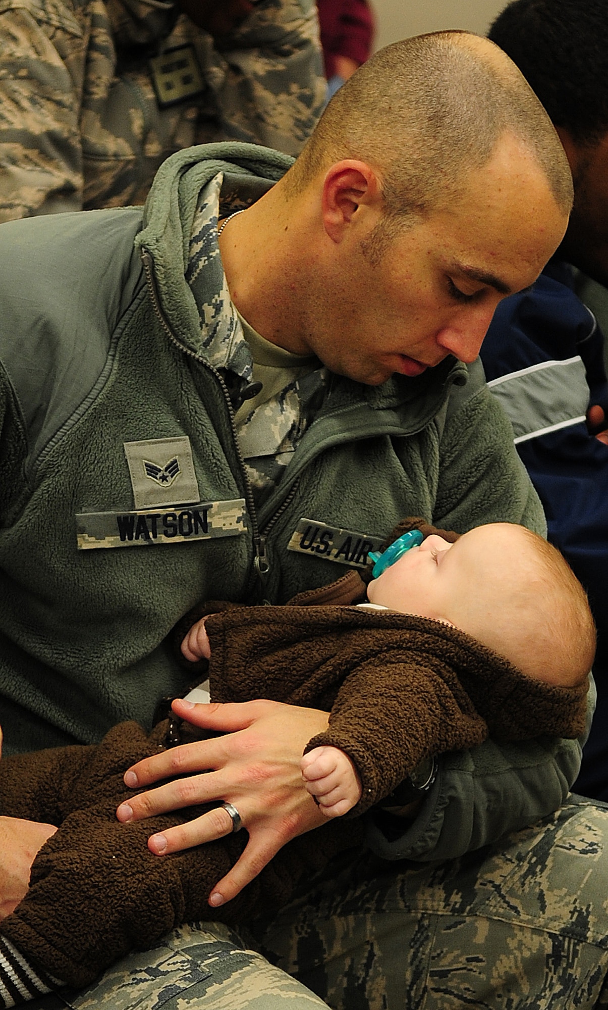 MOODY AIR FORCE BASE, Ga. -- Senior Airman David Watson, 822nd Base Defense Squadron fire team member, takes a moment to say goodbye to his 3-month-old son, Mikah Watson. This is the first deployment to Afghanistan for the 820th Base Defense Group. (U.S. Air Force photo/Senior Airman Stephanie Mancha)(RELEASED) 