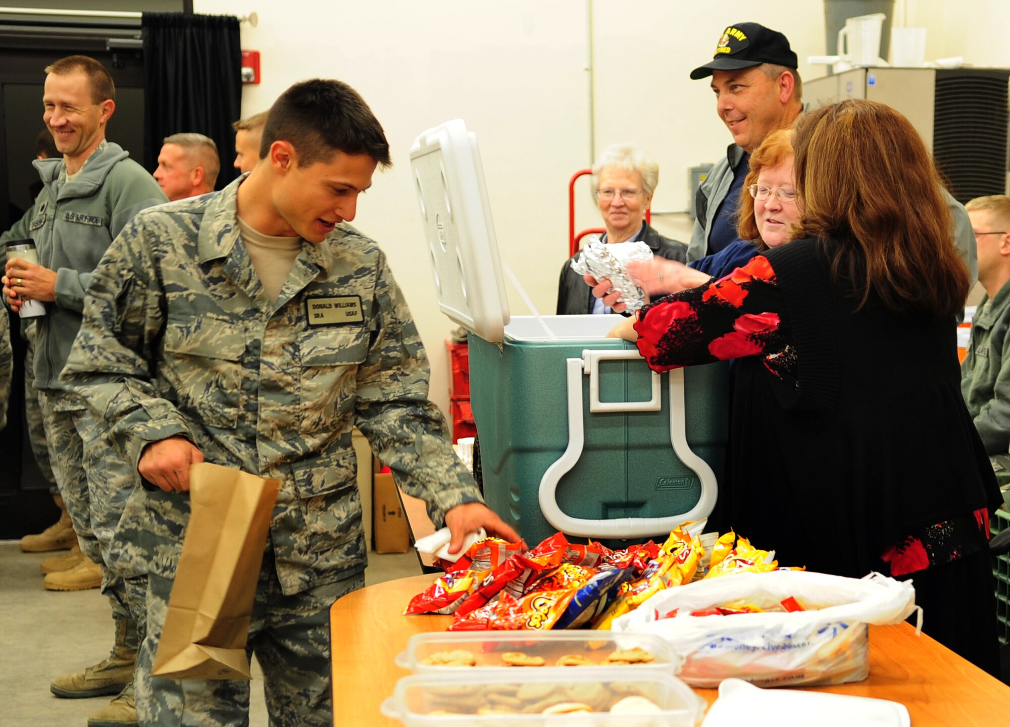 MOODY AIR FORCE BASE, Ga. -- Senior Airman Donald Williams, 822nd Base Defense Squadron patrolman, recently packs a sack meal before loading the bus. Hot dogs, chips, cookies and drinks were provided by the 23rd Force Support Squadron Airman and Family Readiness Center to support the deployers who will be heading to Afghanistan. (U.S. Air Force photo/Senior Airman Stephanie Mancha)(RELEASED)