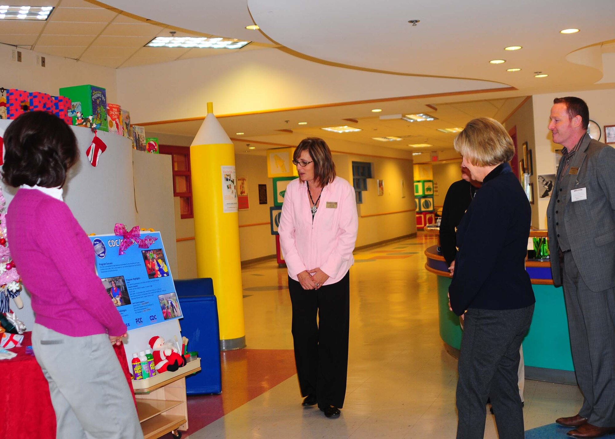 ALTUS AIR FORCE BASE, Okla.--Laurie Salafia, Altus Child Development Center assistant chief, briefs Mrs. Leah Thomas, wife of the 97th Air Mobility Wing commander, Mrs. Patty Solo, wife of 19th Air Force Commander Major General Mark Solo, and Anthony Raas, 97th Force Support Squadron, on the different programs offered at the Altus CDC Dec. 2.  During the tour, Mrs. Solo was updated on the changes the CDC has undergone as well as the facility's accomplishments. (U.S. Air Force photo/Senior Airman Leandra D. Stepp/Released 97th Air Mobility Wing Public Affairs)
