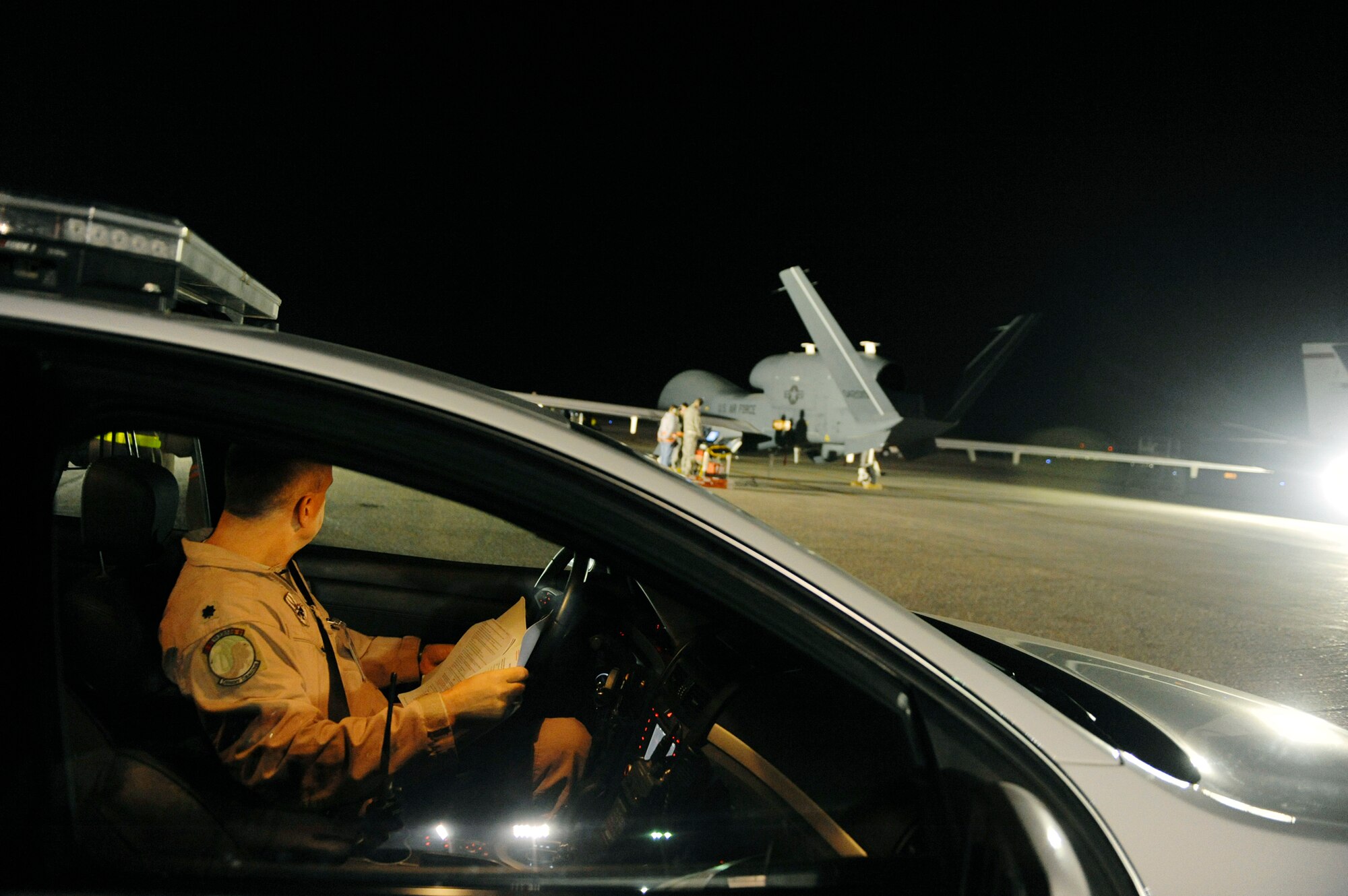 A lieutenant colonel from the 99th Expeditionary Reconnaissance Squadron waits in his vehicle before an EQ-4 Global Hawk's first launch Nov. 29, 2010, in Southwest Asia. The EQ-4 and other Global Hawk platforms use a chase vehicle to ensure the aircraft takes off successfully. (U.S. Air Force photo/Staff Sgt. Eric Harris)