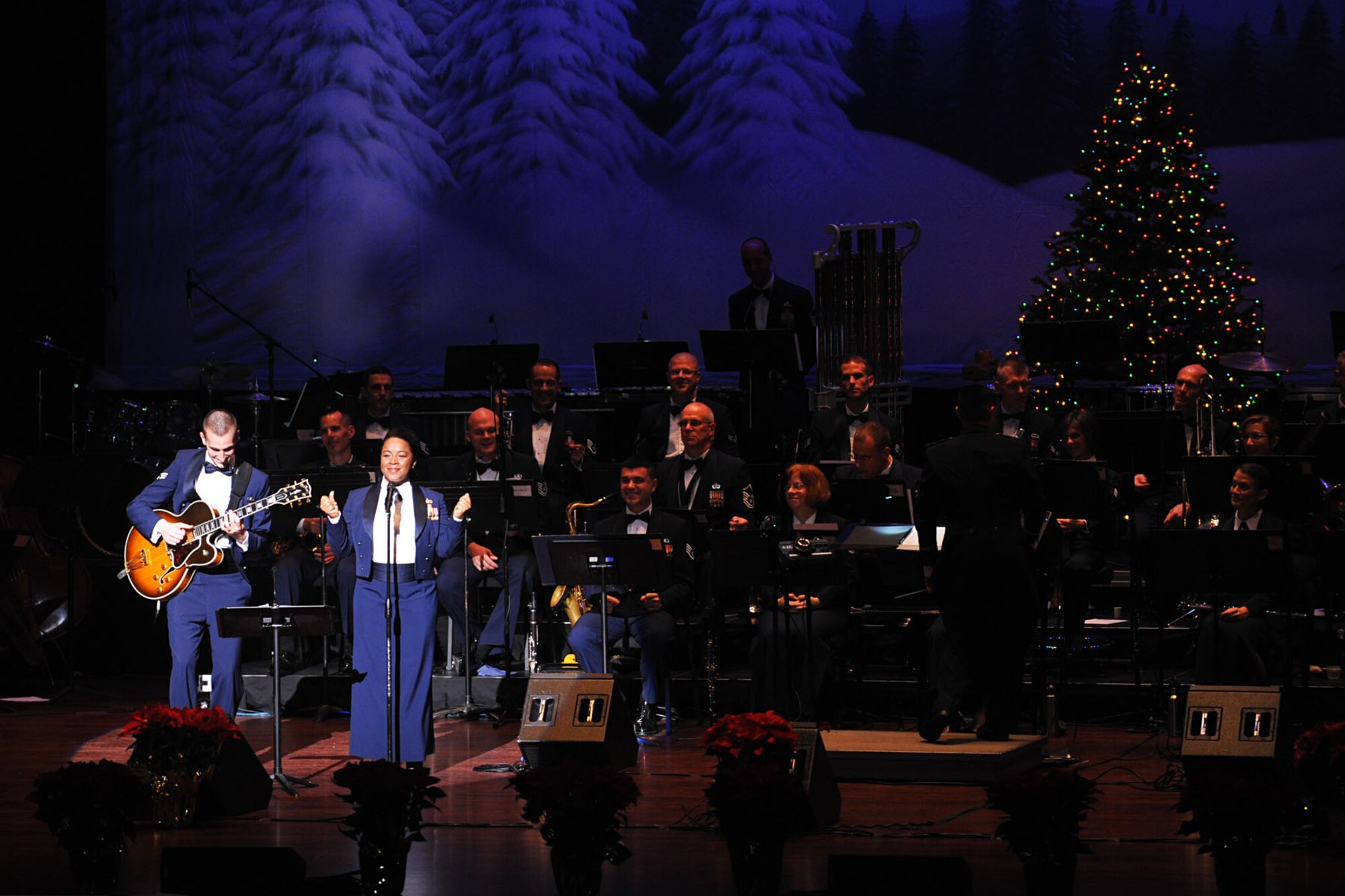 NEWPORT NEWS, Va. -- Heritage of America Band, Air Combat Command, guitarist Senior Airman Aaron Weibe, (left), and vocalist Staff Sgt. Natalie Madison perform White Christmas during the holiday concert at the Christopher Newport University's Ferguson Center for the Arts, Dec. 2. The annual event is a series of concerts held by the band as a means to say thank you to the local community for their support for military personnel. (U.S. Air Force photo/Staff Sgt. Ashley Hawkins)(RELEASED)