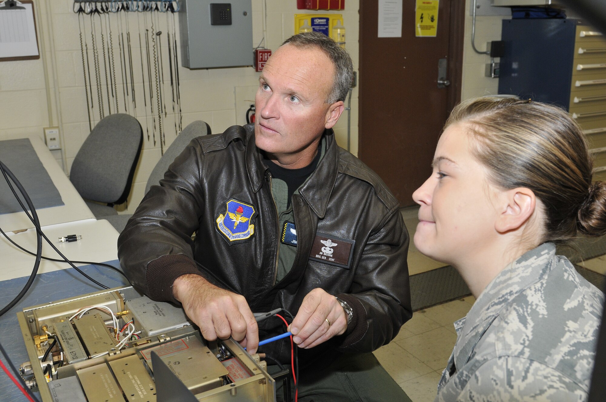 Brigadier Gen. James Browne, 325th Fighter Wing commander, shadows Senior Airman Kayla Draves, 325th Communication Squadron Radio Frequency Transmission Systems Technician, while she conducted her daily duties Dec. 3, as part of the Commander’s Shadow Program.  (U.S. Air Force photo/Lisa Norman)