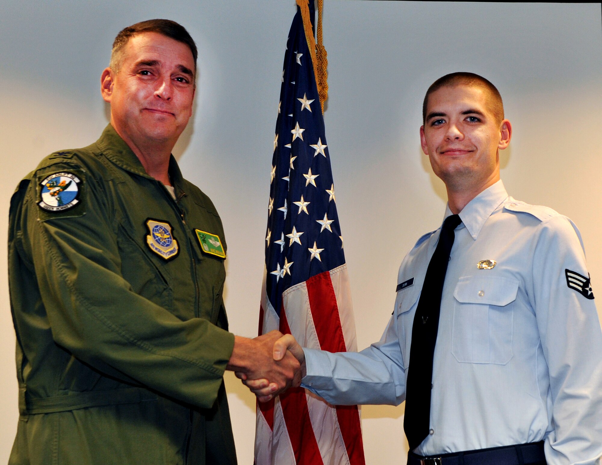 Col. Mike Minihan, 19th Airlift Wing commander, presents a coin Dec. 6, 2010, to Senior Airman Francis “Elwyn” Dunn, a 19th Contracting Squadron contract specialist, for his selection as the Combat Airlifter of the Week at Little Rock Air Force Base, Ark. Airman Dunn awarded approximately $750,000 furniture and classroom information technology equipment purchases, which furnished the first-of-its-kind Joint Education Center, partially funded by a $5 million gift from the citizens of Jacksonville. (U.S. Air Force photo by Senior Airman Gul Crockett)