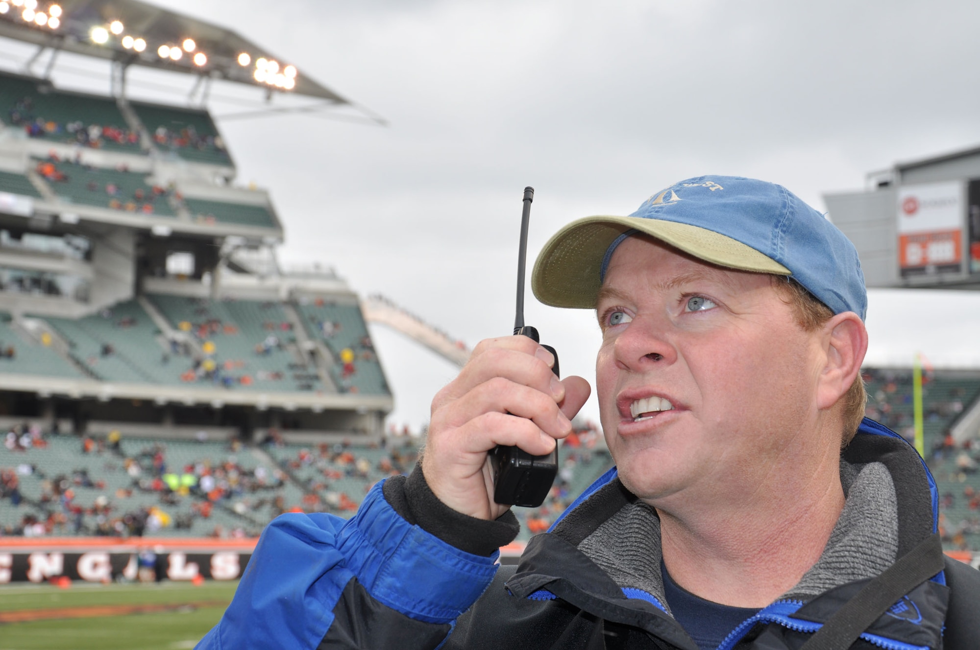 WRIGHT-PATTERSON AIR FORCE BASE, Ohio – Chief Master Sgt. Joe Gough, 89th Airlift Squadron, coordinates via radio contact from the ground with the crew of a 445th Airlift Wing C-5 Galaxy preparing to perform a flyover over Paul Brown Stadium prior to the start of the Dec. 5 Cincinnati Bengals vs. New Orleans Saints football game.  (U.S. Air Force photo/Tech. Sgt. Jeremy Caskey)