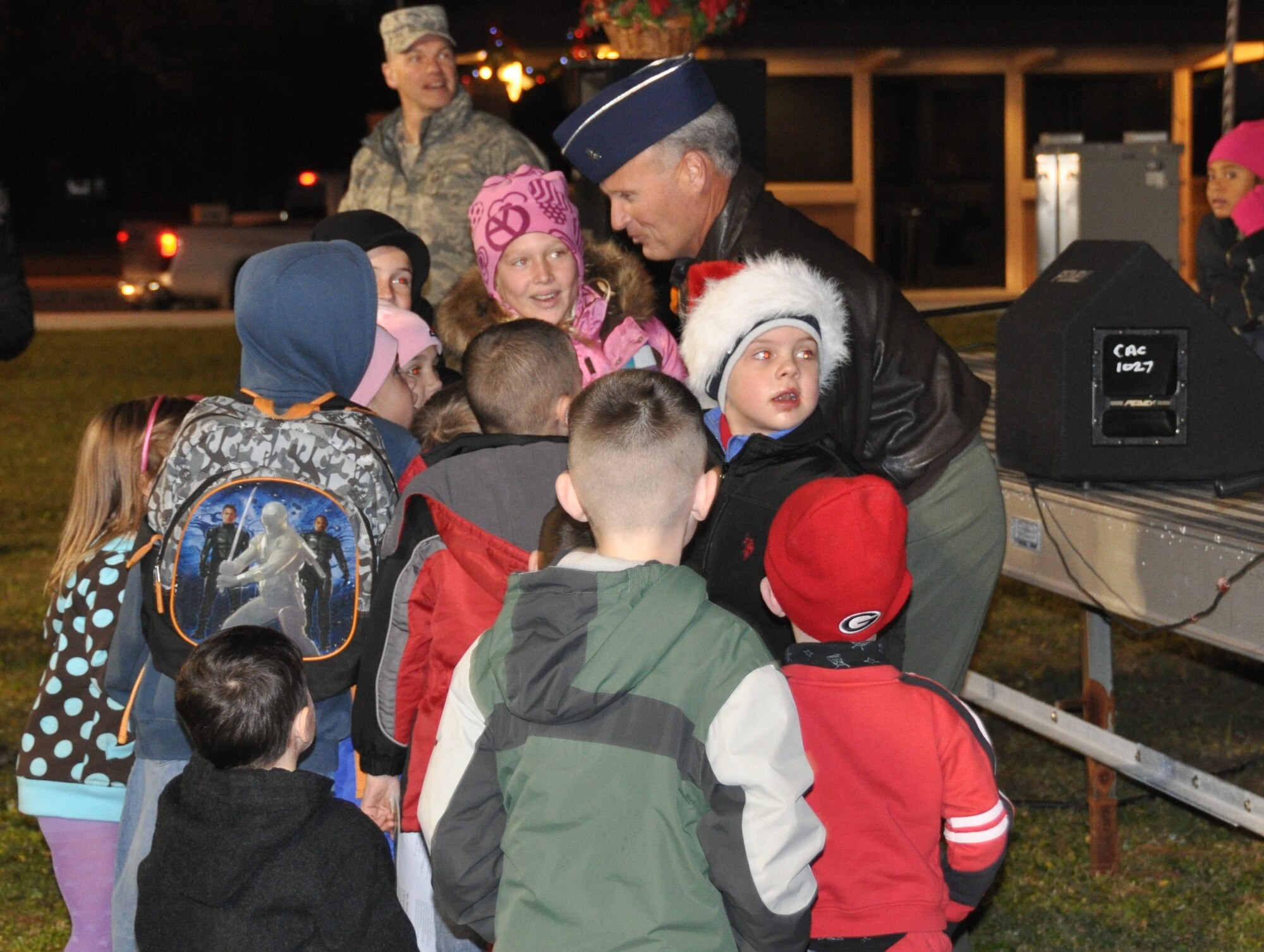 Brigadier Gen. James Browne, 325th Fighter Wing commander, gathers with some of the Tyndall children to switch on the lights to the tree, opening the ceremony.  