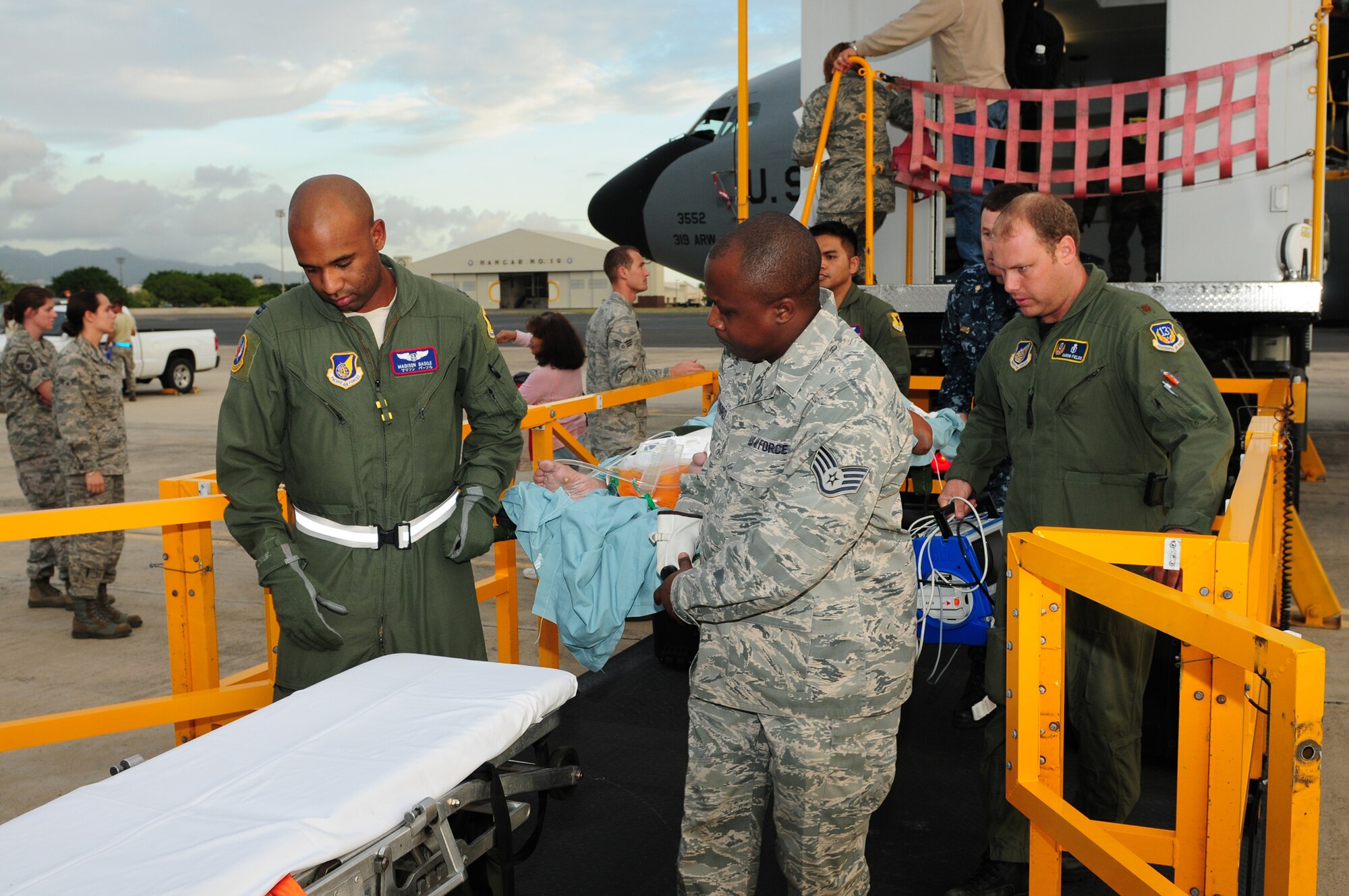 Medical personnel transport a critically ill patient from a KC-135 Stratotanker to Tripler Army Medical Center Nov. 17, 2010. This is the first time CCATT East element has transported a critically ill patient during peacetime. The CCATT is a specialized, three-person medical team whose primary mission is to provide critical-care management for critically ill or injured patients who require transport to advanced medical treatment facilities. The medical team is from the 18th Aeromedical Evacuation Squadron at Kaden Air Base Japan; the 15th Medical Group and Critical Care Air Transport Team East element at Joint Base Pearl Harbor-Hickam, Hawaii; and Tripler Army Medical Center, Hawaii, (U.S. Air Force photo/Tech. Sgt. Kerry Jackson) 