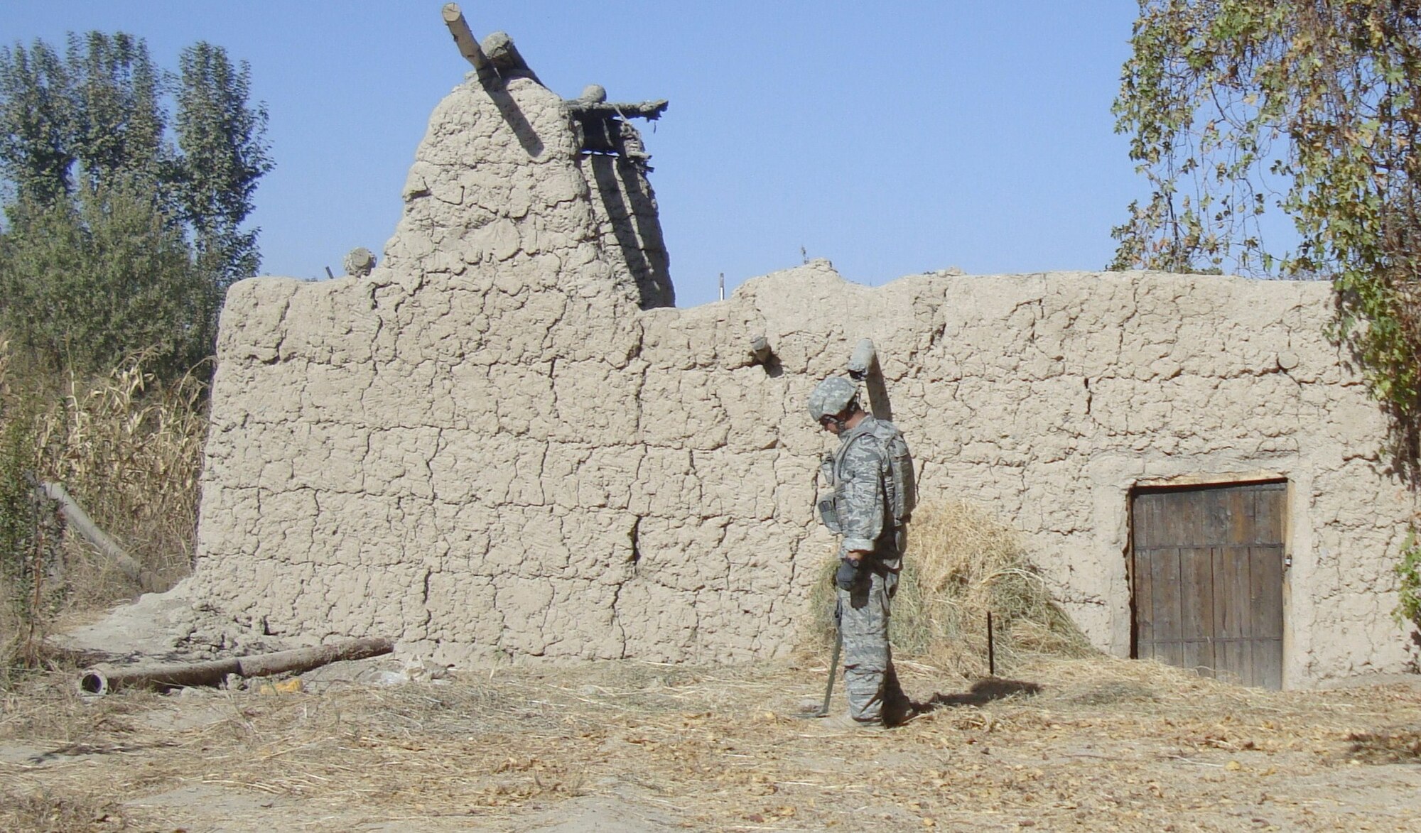 ARGHANDAB RIVER VALLEY, AFGHANISTAN – Staff Sgt. Michael Burnett, 5th Civil Engineer Squadron noncommissioned officer in charge of EOD quality and assurance, uses a mini mine detector to search for metal signature traces. Detectors like these are used to scan ground terrain for possible pressure plates which trigger improvised explosive devices. EOD Airmen frequently deploy to areas like Afghanistan and Iraq because of their expertise in dealing with IED’s, weaponry continually used by insurgents in these areas. (Photo courtesy/Staff Sgt. Michael Burnett)