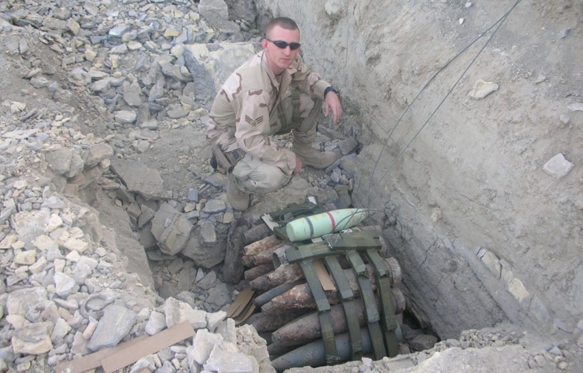 ALI AIR BASE, IRAQ -- Staff Sgt. Haven Cherry, 5th Civil Engineer Squadron noncommissioned officer in charge of explosive ordinance disposal supply and munitions, constantly dealt with the containment of explosive weaponry caches such as this one during his deployment to Iraq. Caches of unexploded ordinances are used as improvised explosive device weaponry against coalition troops in combat environments overseas.  EOD Airmen are in a highly demanding career field because of their extensive expertise in dealing with IED’s. (Photo courtesy/Staff Sgt. Haven Cherry)