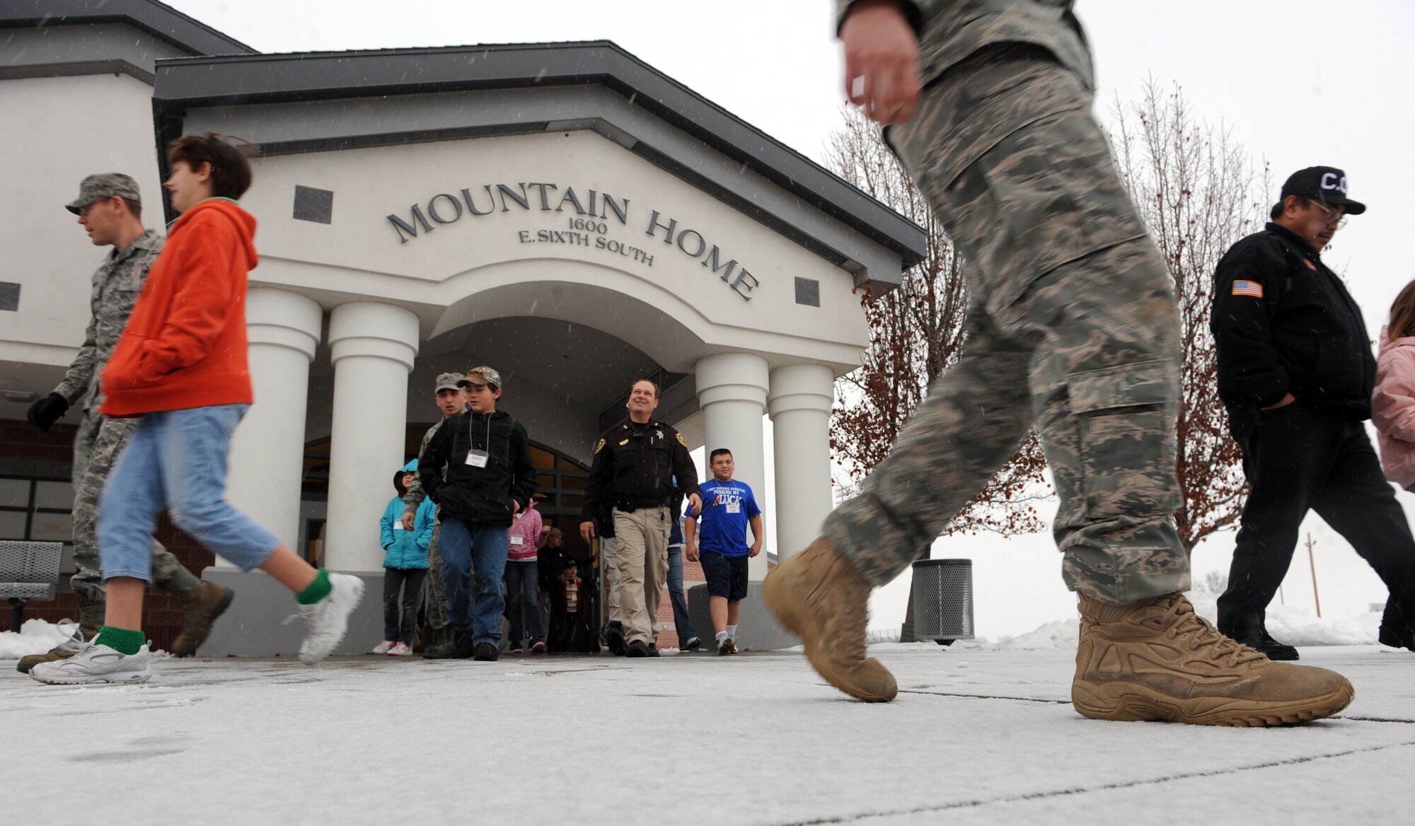 MOUNTAIN HOME, Idaho -- Children and chaperones leave Mountain Home Junior High School to go shopping during the shop with a cop event in Mountain Home, Dec. 4. Local businesses and agencies made donations to give more than 100 needy children the chance to have a merry Christmas. (U.S. Air Force photo by Senior Airman Debbie Lockhart)