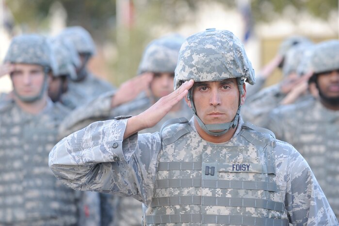 U.S. Air Force Capt. Matthew Foisy salutes during a retreat ceremony at Joint Base Charleston-Air Base, S.C., Dec. 3, 2010. The ceremony serves a twofold purpose. It signals the end of the official duty day and also serves as a ceremony for paying respect to the flag. Captain Foisy is the acting commander of the 628th Security Forces Squadron. (U.S. Air Force photo/James M. Bowman)