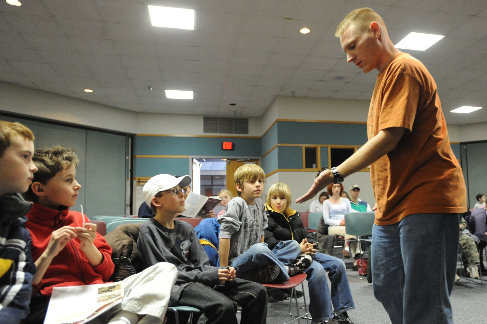 WHITEMAN AIR FORCE BASE, Mo - Maj. KJ Vezino, 72nd Test and Evaluation Squadron chief engineer, also known as spider-man, allows children to pet his Mexican redrump tarantuala during the snake lady and spider-man presentation, Dec. 4. Major Vezino brought a variety of spiders to teach Team Whiteman about the arachnids. (U.S. Air Force photo by senior Airman Carlin Leslie)