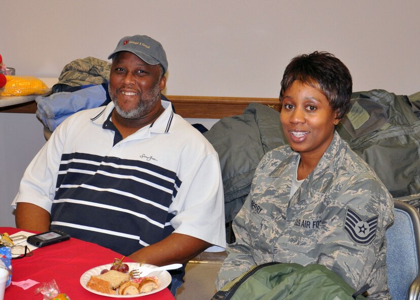 WRIGHT-PATTERSON AIR FORCE BASE, Ohio – Tech. Sgt. Monique Dewberry, 445th Operations Group, spends some time with residents staying at the Dayton VA Medical Center Dec. 4.  Airmen of 445th Airlift Wing attend the annual Christmas party and provide gifts and companionship to local VA residents. (U.S. Air Force photo/Senior Airman Matthew Cook)