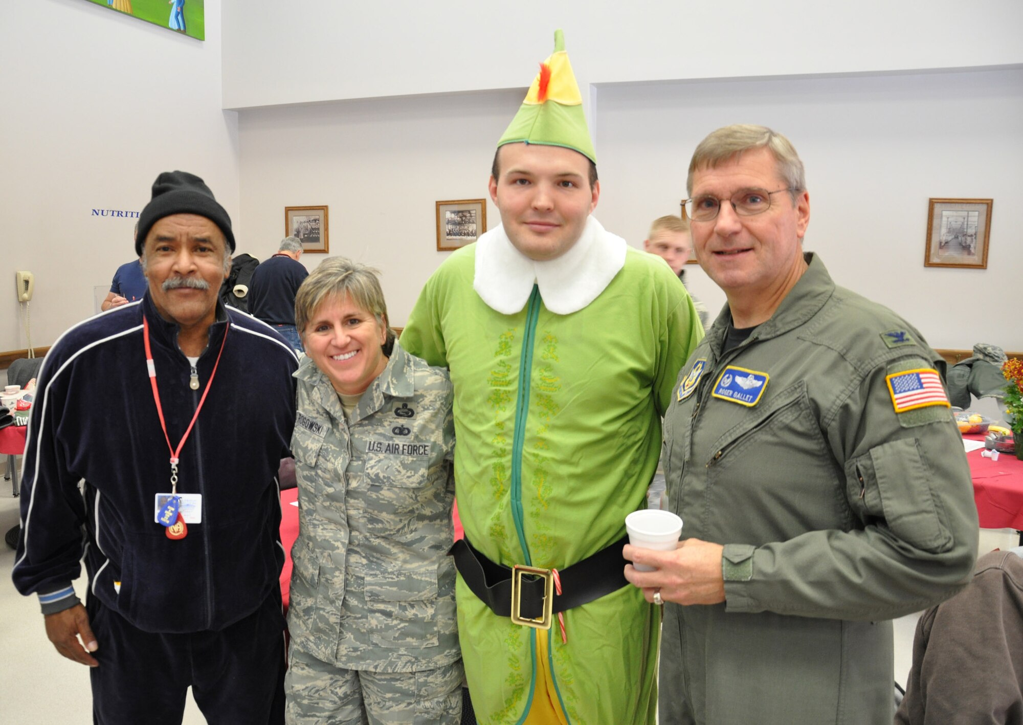 WRIGHT-PATTERSON AIR FORCE BASE, Ohio – Dressed as an elf, Staff Sgt. Jordan West, 87th Aerial Port Squadron, spent the morning spreading holiday cheer for the residents at the Dayton VA Medical Center Dec. 4.  Chief Master Sgt. Peri Rogowski, 445th Airlift Wing command chief, and Col. Roger Gallet, 445th Operations Group, also joined in on the festivities.  Airmen of 445th Airlift Wing attend the annual Christmas party and provide gifts and companionship to local VA residents. (U.S. Air Force photo/Senior Airman Mikhail Berlin)