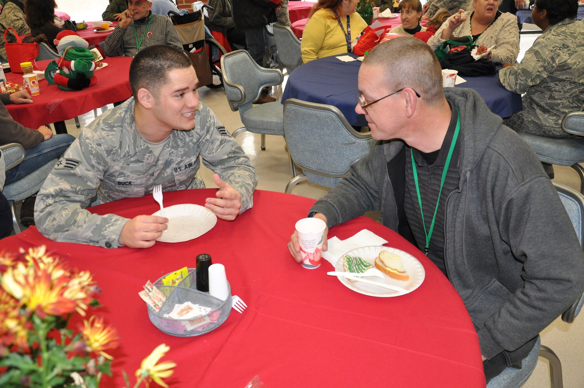 WRIGHT-PATTERSON AIR FORCE BASE, Ohio – Senior Airman Joshua Buck, 445th Force Support Squadron, spends some time with Mr. Dave Chambers, a resident at the Dayton VA Medical Center, Dec. 4.  Airmen of 445th Airlift Wing attend the annual Christmas party and provide gifts and companionship to local VA residents. (U.S. Air Force photo/Senior Airman Mikhail Berlin)