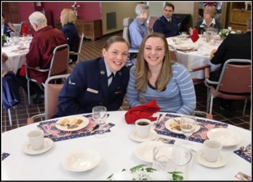 Airman Basic Mara Puetz, 103rd Airlift Wing, shares a smile with a friend over lunch at the Little Sisters of the Poor residence home in Enfield, Conn. on Veterans Day, Nov. 11, 2010. The event was the brain child of Kathi Carney, Director of Activities for the home. She reached out through a mutual friend to Chief Master Sgt. Robert Zukauskas who then enlisted the help of six eager volunteers. (Photo courtesy of Chief Master Sgt. Robert Zukauskas)