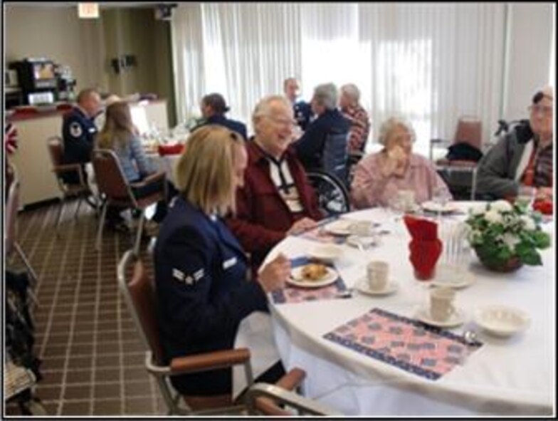 Airman 1st Class Michelle Saucier, 103rd Airlift Wing, talks with residents at the Little Sisters of the Poor residence home in Enfield, Conn. on Veterans Day, Nov. 11, 2010. The event was the brain child of Kathi Carney, Director of Activities for the home. She reached out through a mutual friend to Chief Master Sgt. Robert Zukauskas who then enlisted the help of six eager volunteers. (Photo courtesy of Chief Master Sgt. Robert Zukauskas)