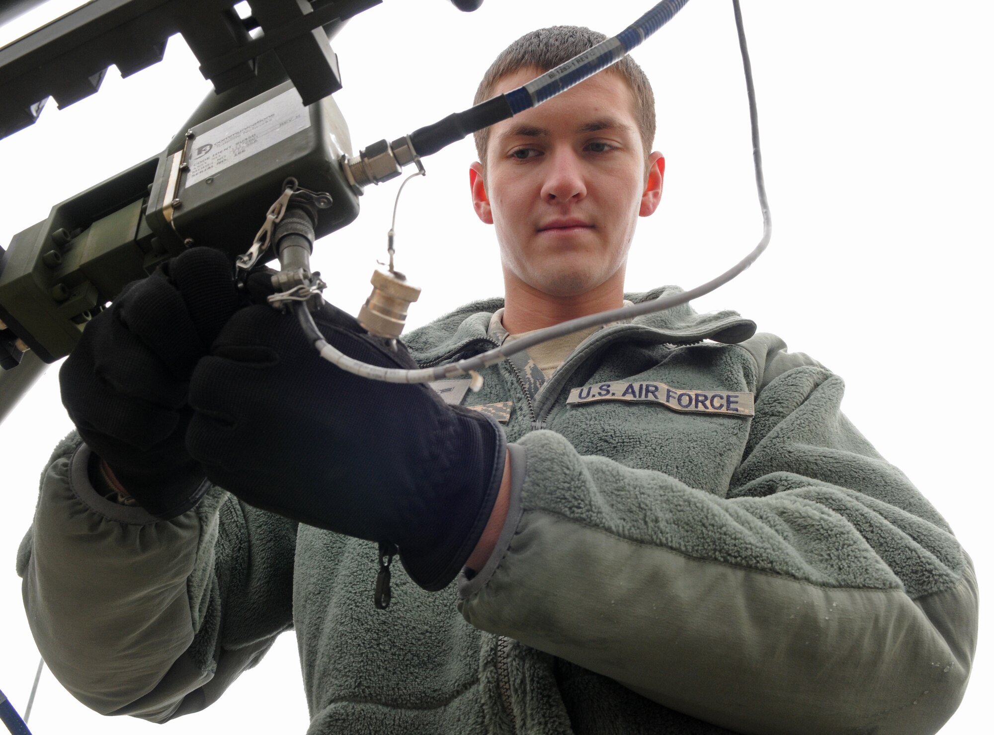 SPANGDAHLEM AIR BASE, Germany – Airman 1st Class Tanner Menzel, 606th Air Control Squadron radio frequency transmissions technician, conducts a preventive maintenance inspection on a satellite communications antenna that provides connectivity to geographically-separated areas Nov. 23. Radio frequency transmissions technicians operate and maintain several satellite terminals and provide connectivity for external forwarding to higher headquarters. (U.S. Air Force photo/Airman 1st Class Matthew B. Fredericks)