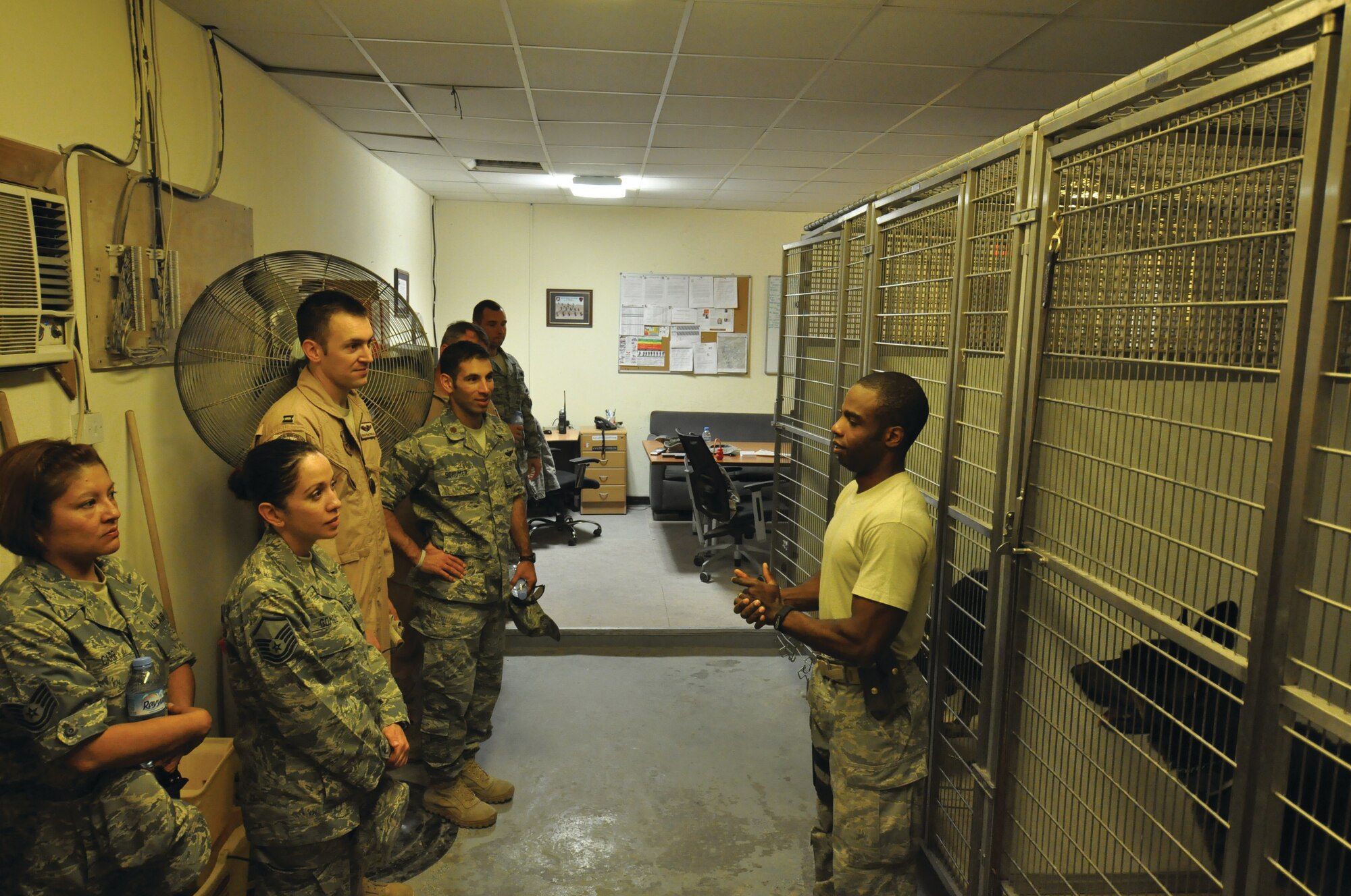 taff Sgt. Rojen Richards, 379th ESFS military working dog handler, takes members of the  746th Expeditionary Airlift Squadron  on a tour through  their facilities and military working dog kennel. The sergeant explains to the group the importance of having the working dogs here and what their primary job entails. The group is then allowed to pose as hostile subjects to get some hands-on experience from the perspective of a handler. Tours such as this one help other members of the base populace to understand the importance of having a K-9 unit on the installation. U.S. Air Force photo/Staff Sgt. Nika Glover.