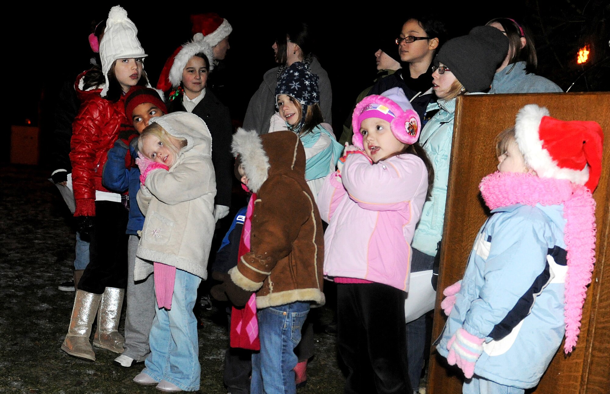 RAF MILDENHALL, England -- The RAF Mildenhall Chapel Children's Choir sings "Away in a manger" at the base Christmas Tree lighting ceremony at the Bob Hope Community Center Dec. 3, 2010. After the tree was lit, Santa arrived in a base fire truck. (U.S. Air Force photo/Senior Airman Tabitha Lee)