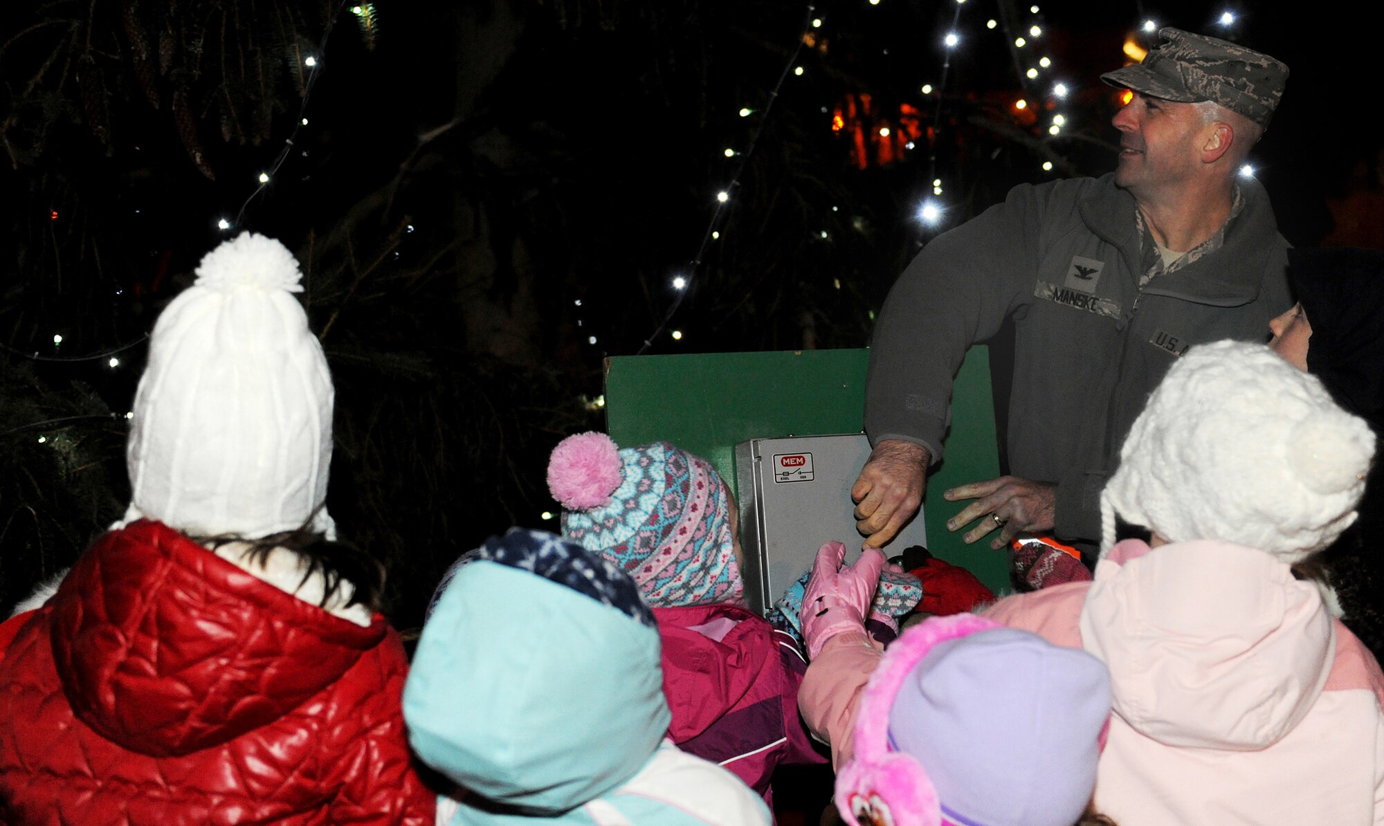 RAF MILDENHALL, England -- The RAF Mildenhall Chapel Children's Choir helps Col. Chad Manske, 100th Air Refueling Wing commander, light the base Christmas Tree Dec. 3, 2010, at the Bob Hope Community Center. (U.S. Air Force photo/Senior Airman Tabitha Lee)