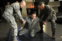 KUNSAN AIR BASE, Republic of Korea -- Chief Master Sgt. Richard Bruno, 8th Security Forces Squadron, reacts to being tased in the back during a training session here Dec. 1.  The taser is the newest non-lethal force asset option for security forces members to use to contain potentially harmful situations. (U.S. Air Force photo/Staff Sgt. Jonathan Pomeroy)
