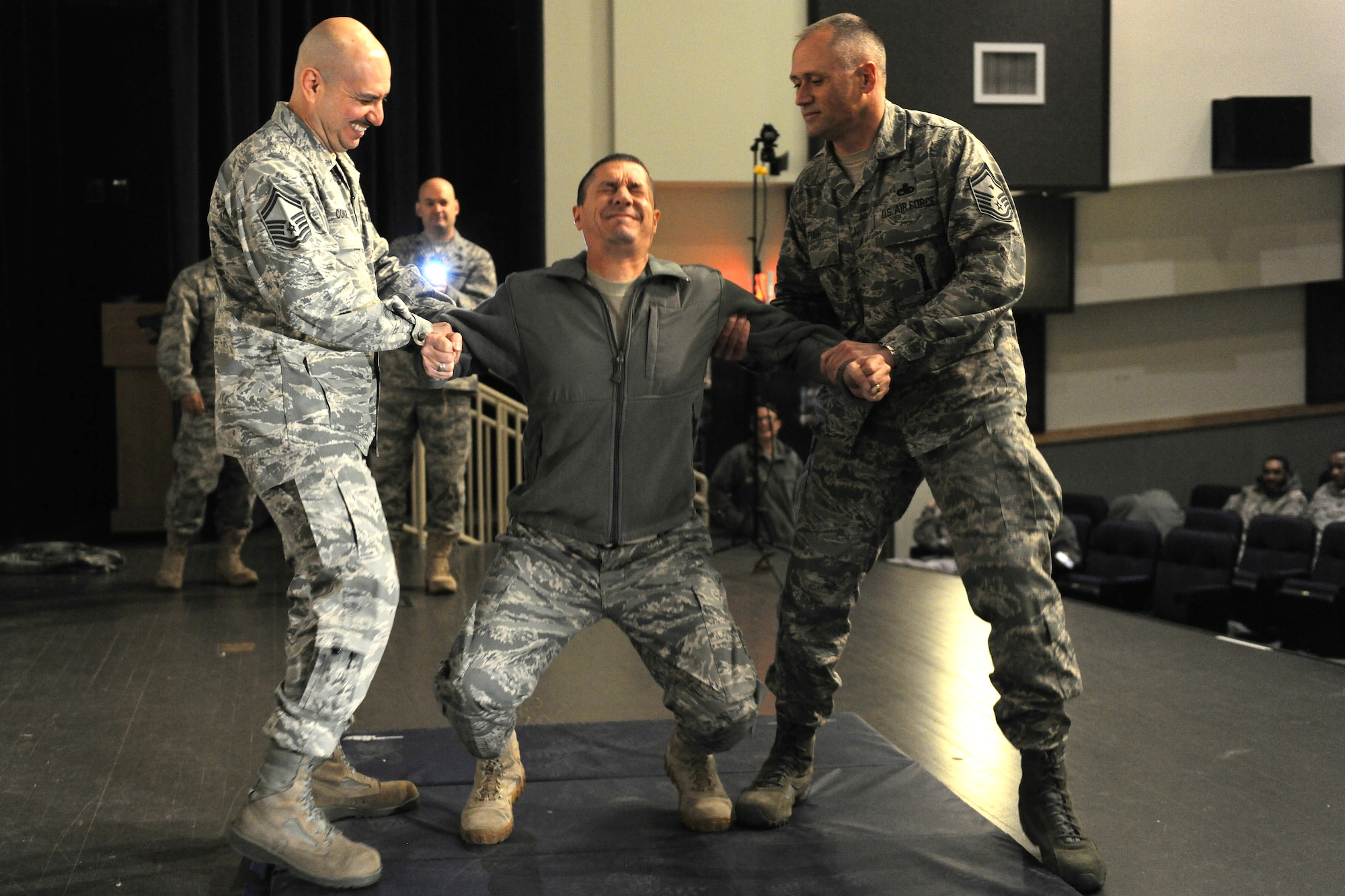 KUNSAN AIR BASE, Republic of Korea -- Chief Master Sgt. Richard Bruno, 8th Security Forces Squadron, reacts to being tased in the back during a training session here Dec. 1.  The taser is the newest non-lethal force asset option for security forces members to use to contain potentially harmful situations. (U.S. Air Force photo/Staff Sgt. Jonathan Pomeroy)
