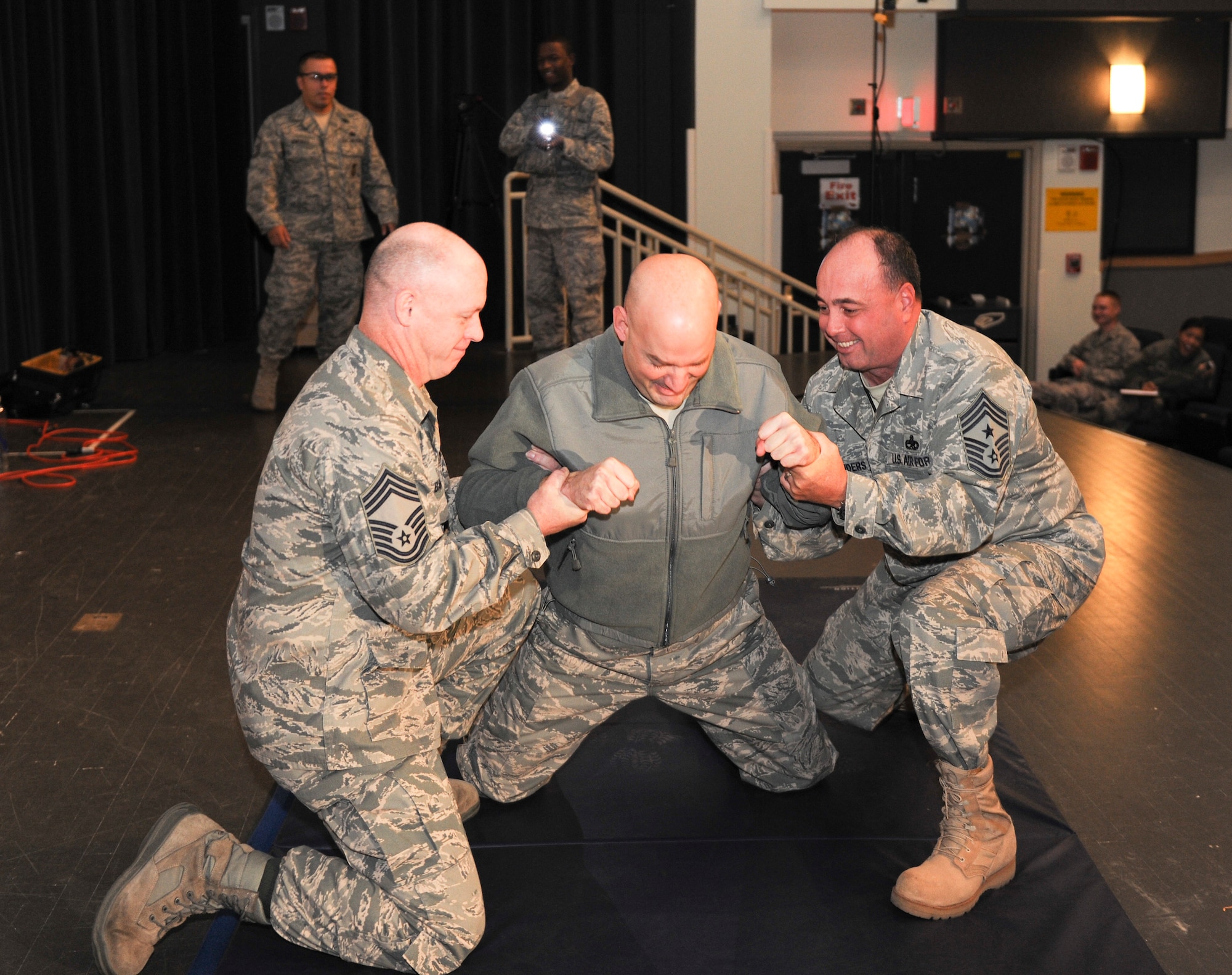KUNSAN AIR BASE, Republic of Korea -- Lt. Col. Mark Anarumo, 8th Security Forces Squadron commander, reacts to being tased in the back during a training session here Dec. 1.  The taser is the newest non-lethal force asset option for security forces members to use to contain potentially harmful situations. (U.S. Air Force photo/Staff Sgt. Jonathan Pomeroy)
