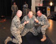 KUNSAN AIR BASE, Republic of Korea -- Lt. Col. Mark Anarumo, 8th Security Forces Squadron commander, reacts to being tased in the back during a training session here Dec. 1.  The taser is the newest non-lethal force asset option for security forces members to use to contain potentially harmful situations. (U.S. Air Force photo/Staff Sgt. Jonathan Pomeroy)
