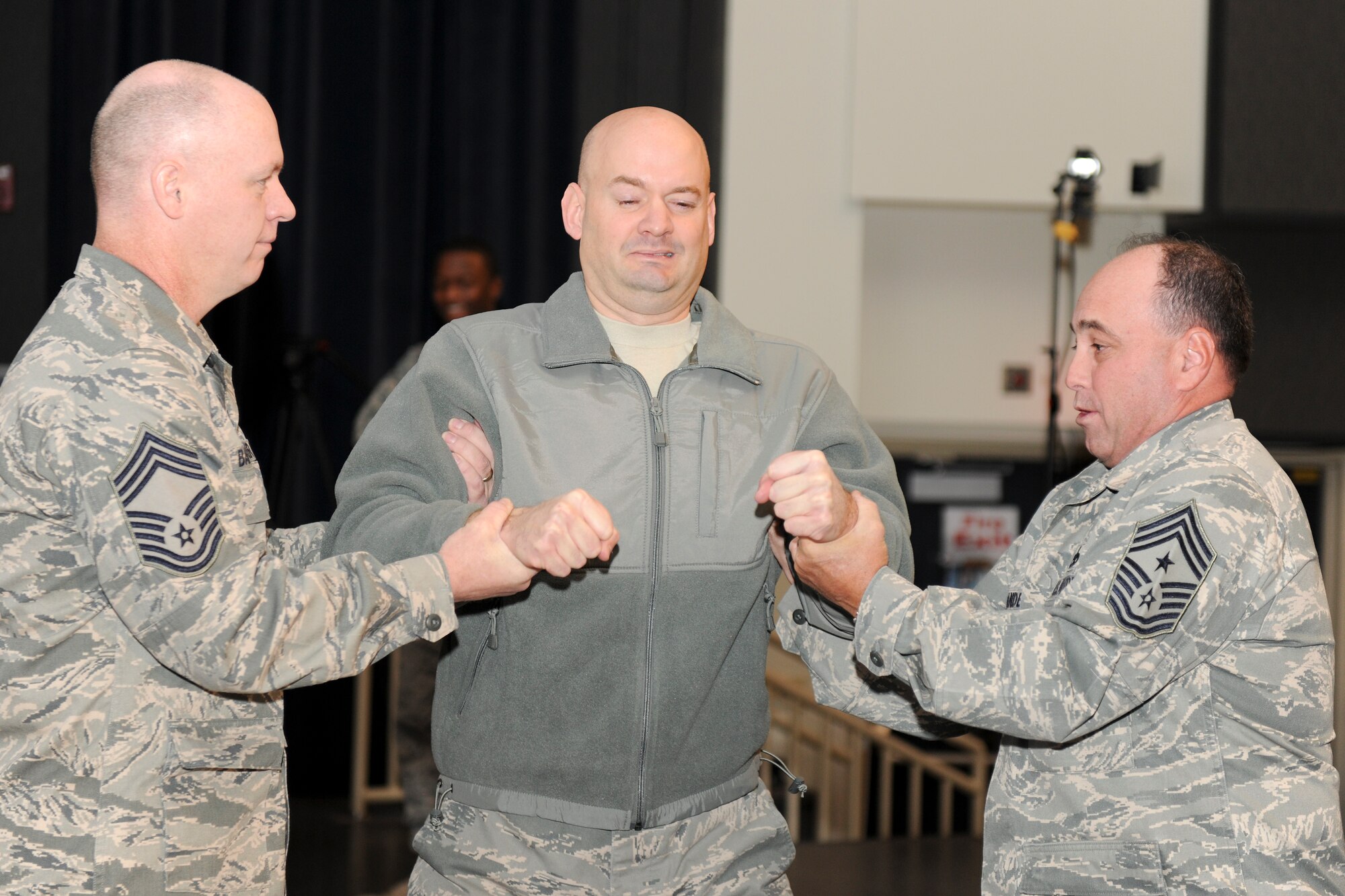 KUNSAN AIR BASE, Republic of Korea -- Lt. Col. Mark Anarumo, 8th Security Forces Squadron commander, reacts to being tased in the back during a training session here Dec. 1.  The taser is the newest non-lethal force asset option for security forces members to use to contain potentially harmful situations. (U.S. Air Force photo/Staff Sgt. Jonathan Pomeroy)
