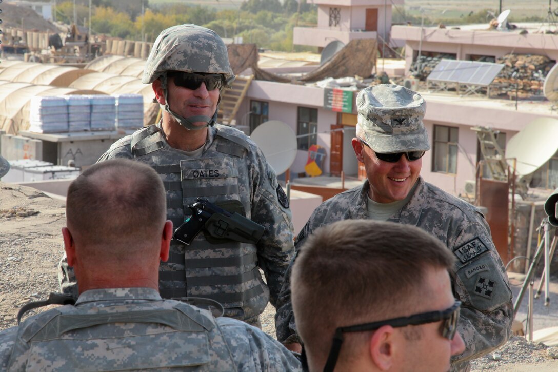 Army Lt. Gen. Michael L. Oates, left, director of the Joint Improvised Explosive Device Defeat Organization, and Col. Jeffery Martindale, right, with the International Security Assistance Force, wait for a helicopter in Aghrandab District Center, Kandahar province, Afghanistan, Oct. 13, 2010. Oates visited the district center to review operations. U.S. Army photo by Spc. Ian Schell